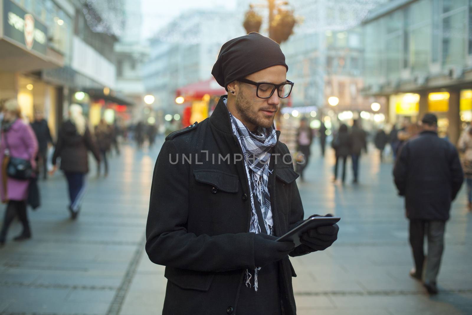 Young man searching information using an tablet computer.