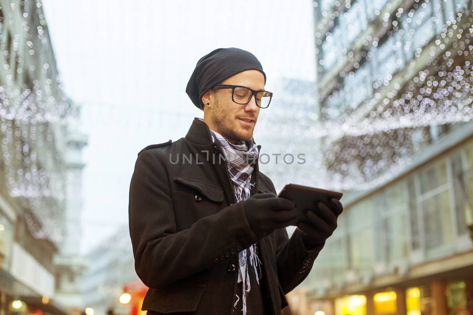 Urban man holdin tablet computer on street by adamr