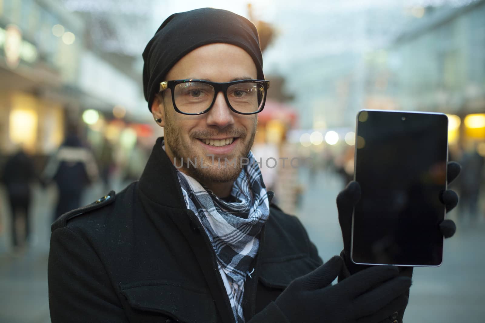 Urban man holdin tablet computer on street by adamr