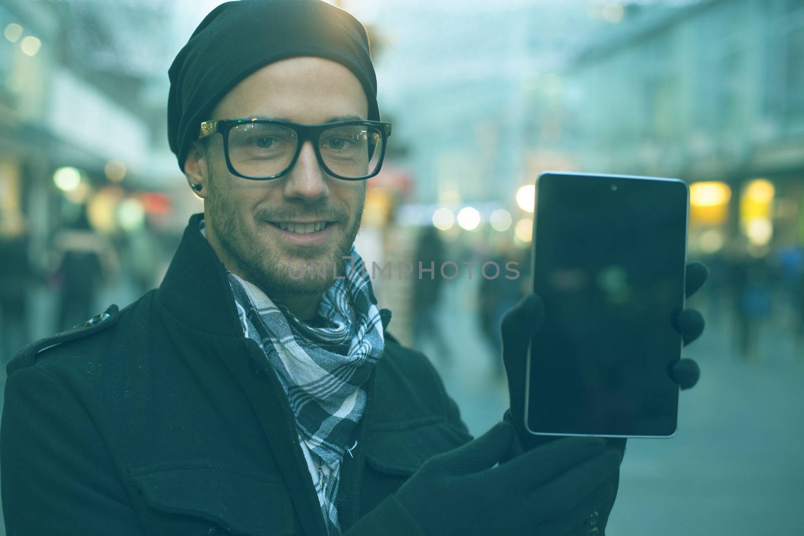 Urban man holdin tablet computer on street by adamr