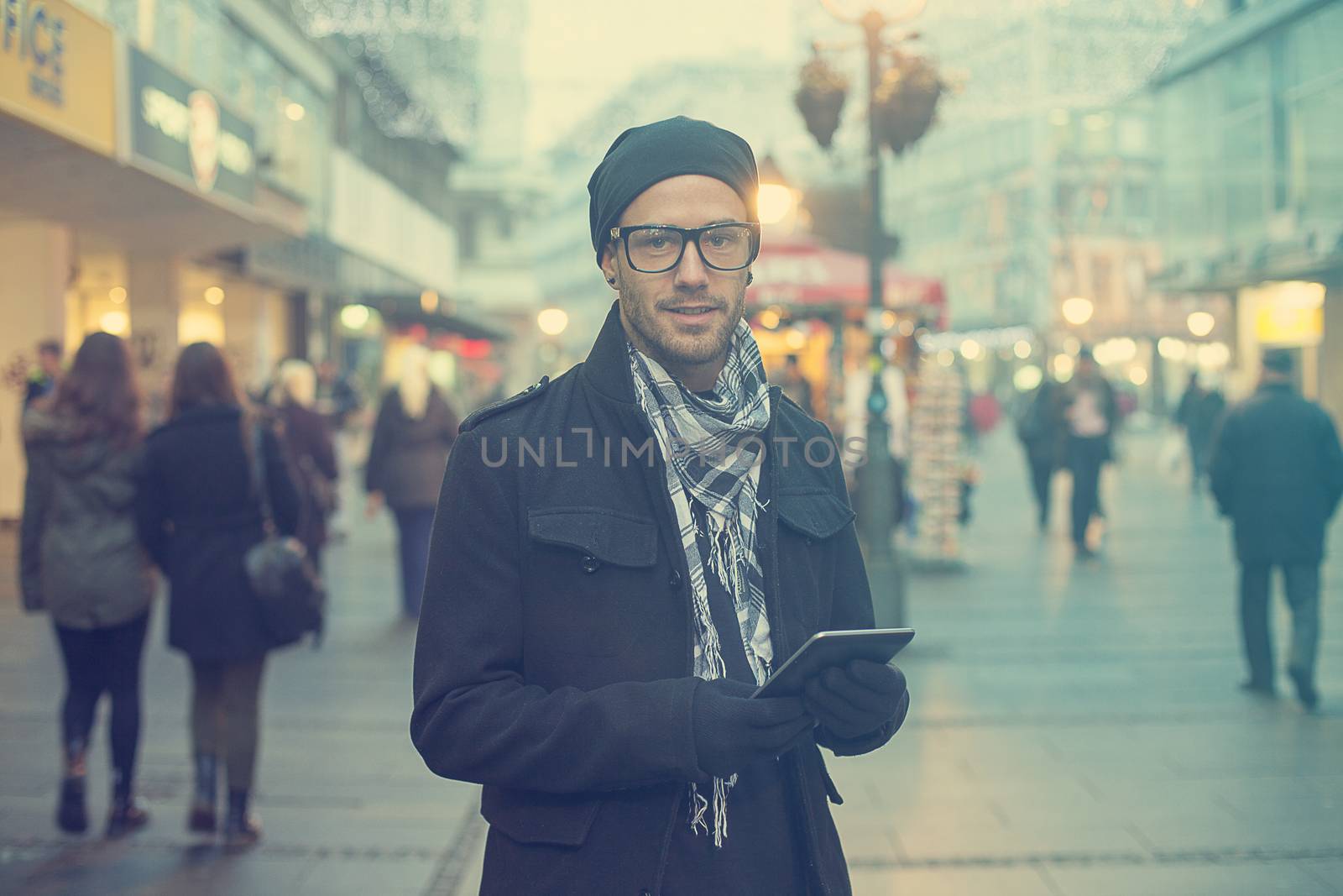 Urban man holdin tablet computer on street by adamr