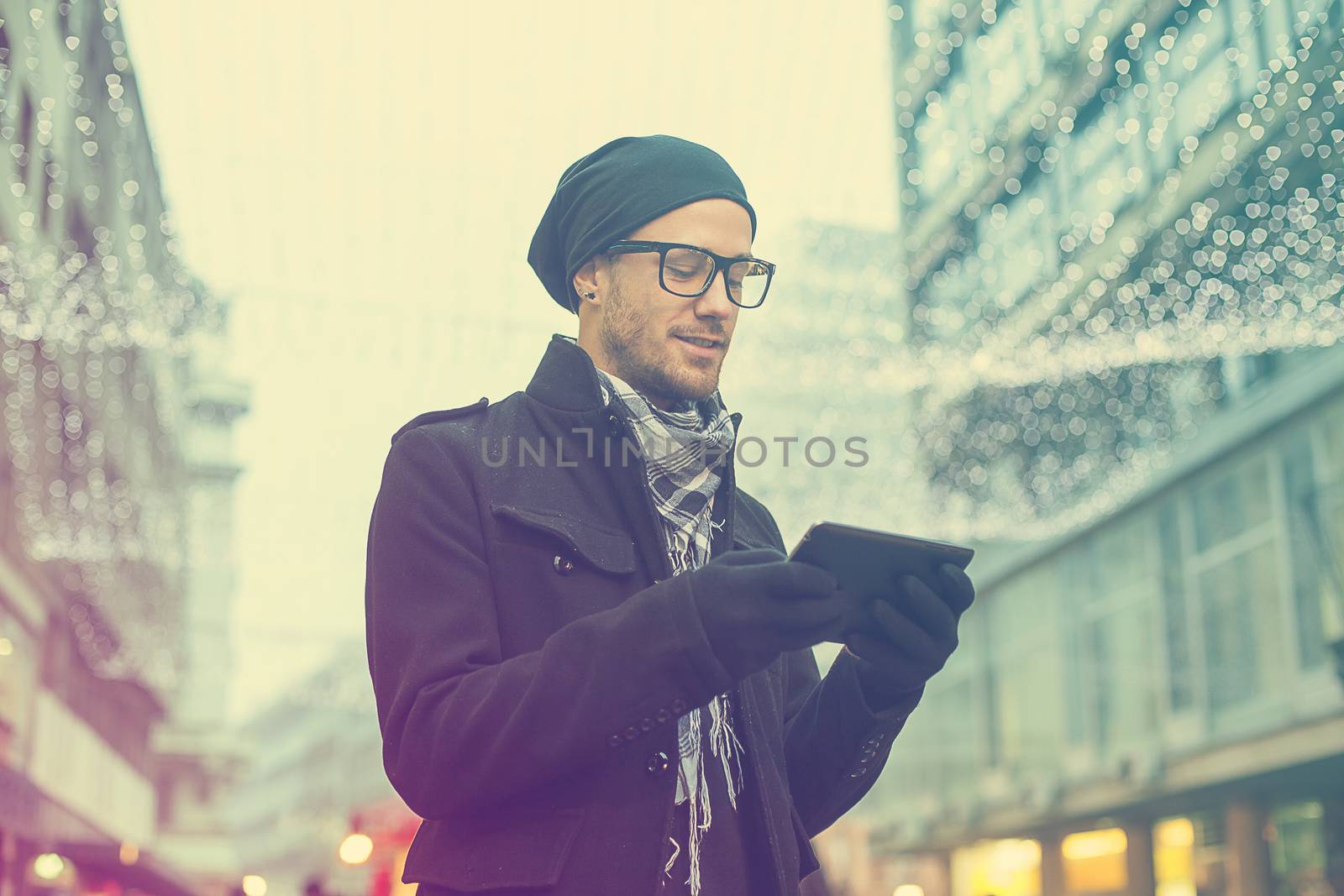 Urban man holdin tablet computer on street by adamr