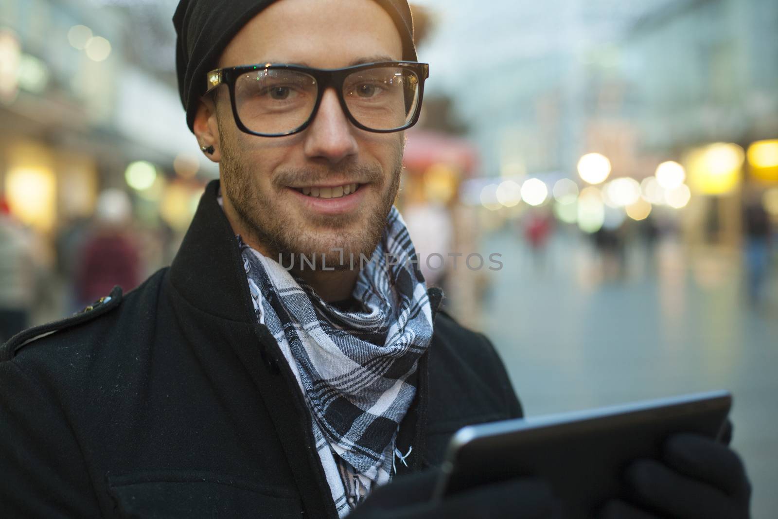 Urban man holdin tablet computer on street by adamr