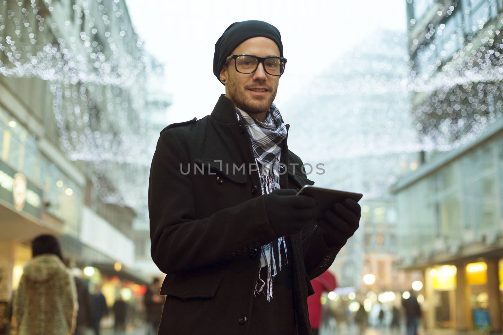 Urban man holdin tablet computer on street by adamr