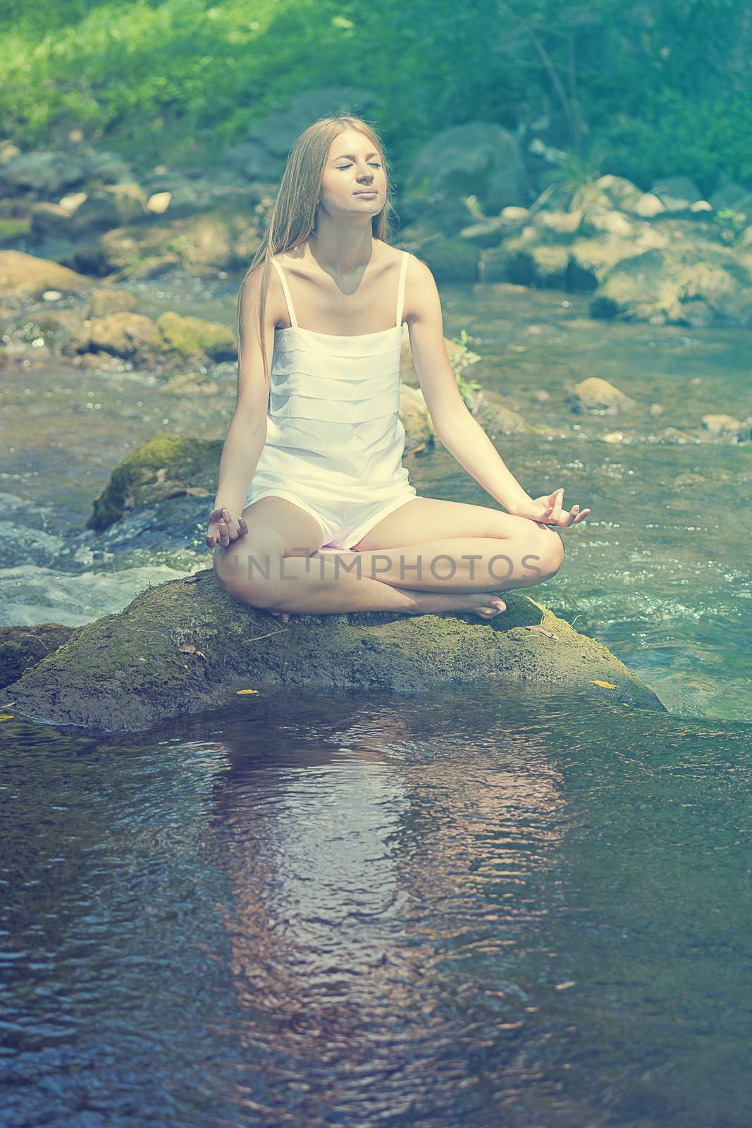 Beautiful Woman Practive Yoga On River In Nature by adamr