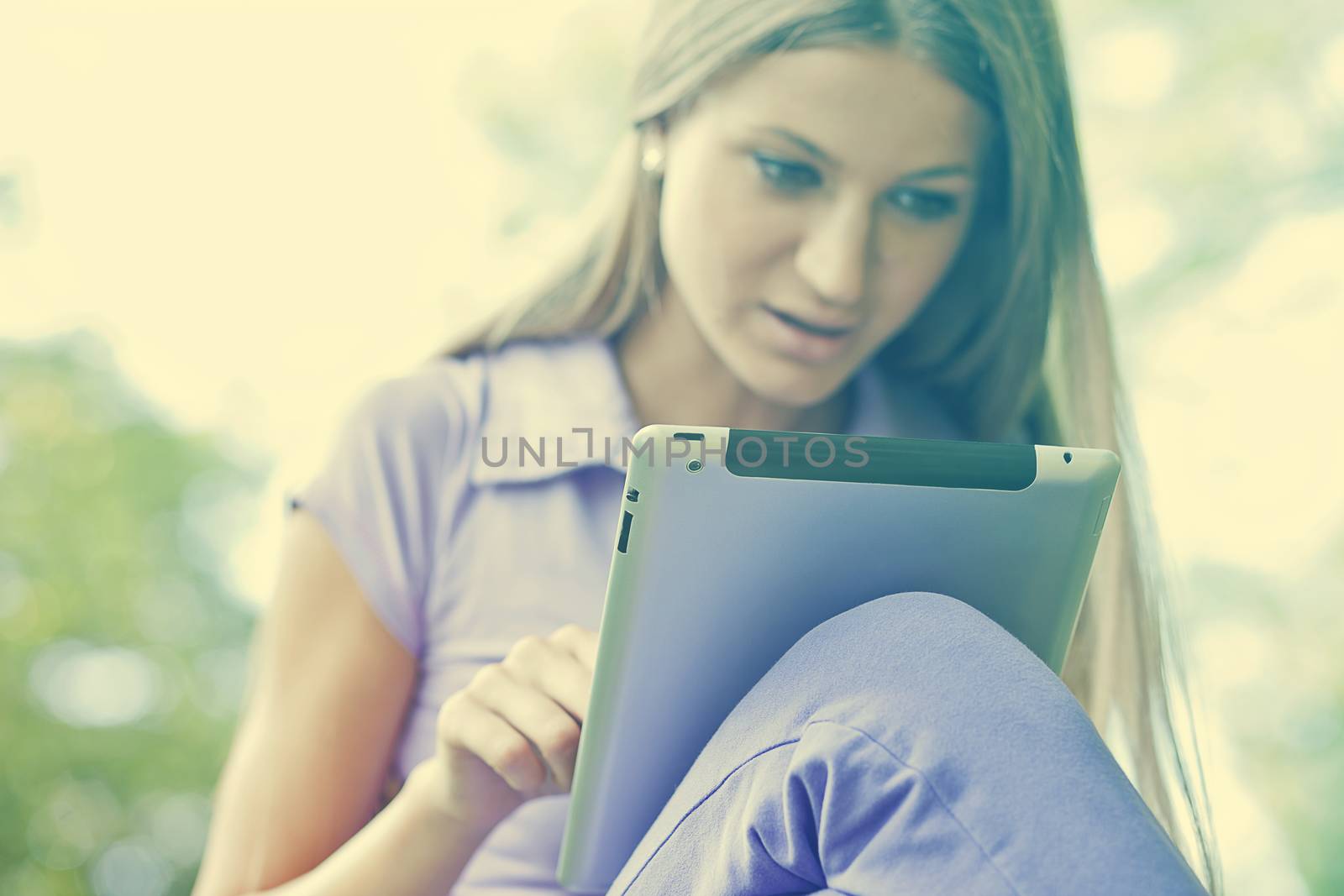 Beautiful Young Woman With Tablet Computer In Park