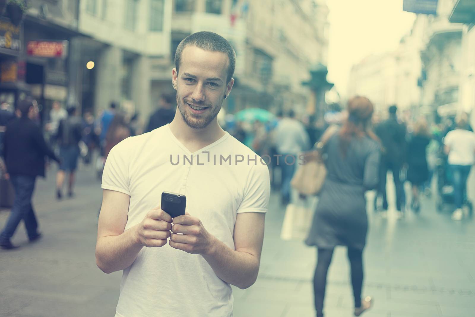 Smiling Man with cell phone walking by adamr