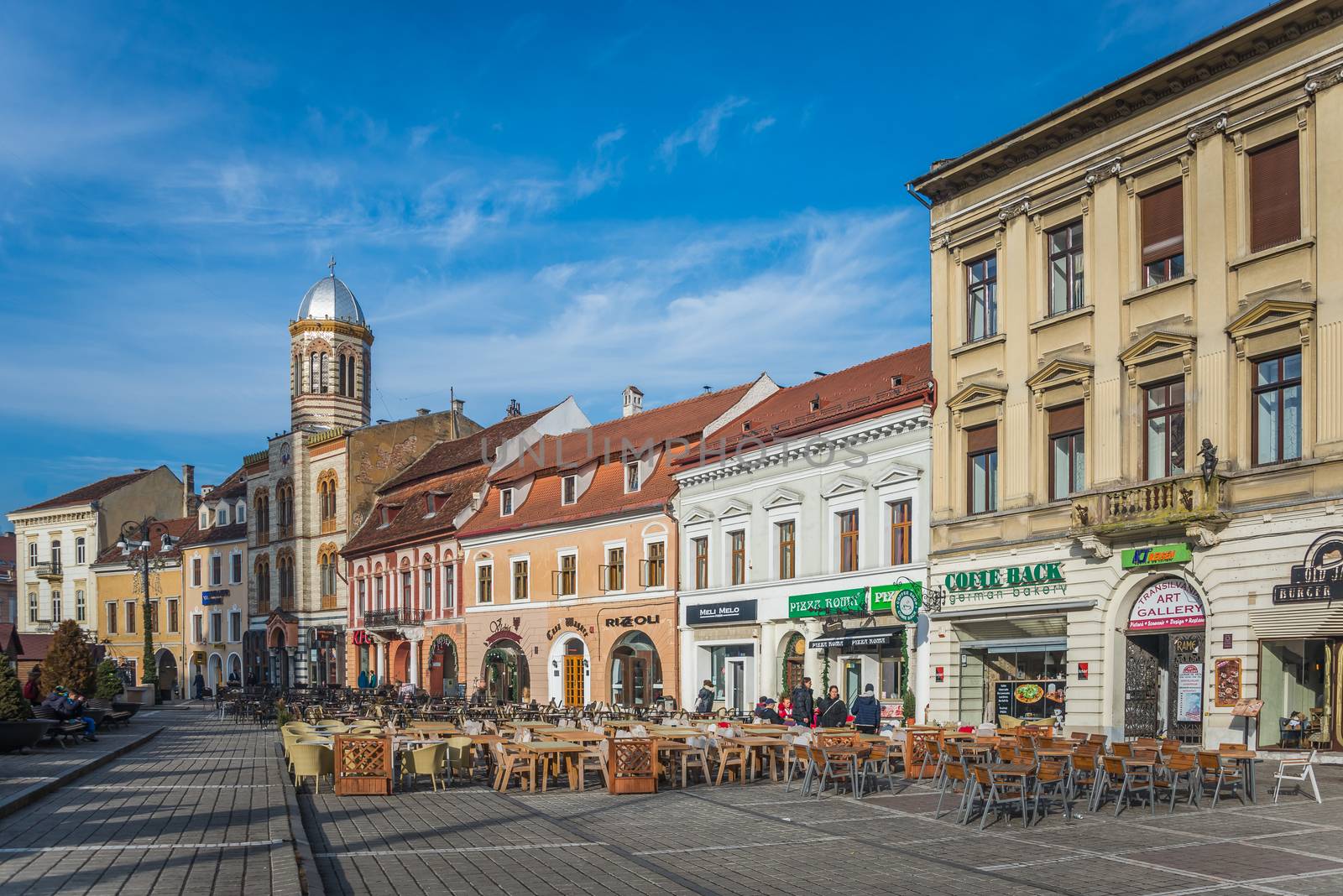 BRASOV, ROMANIA - 01.08.2018. Brasov Town Hall Square in Romania in a sunny winter day at Christmas and New Year holidays