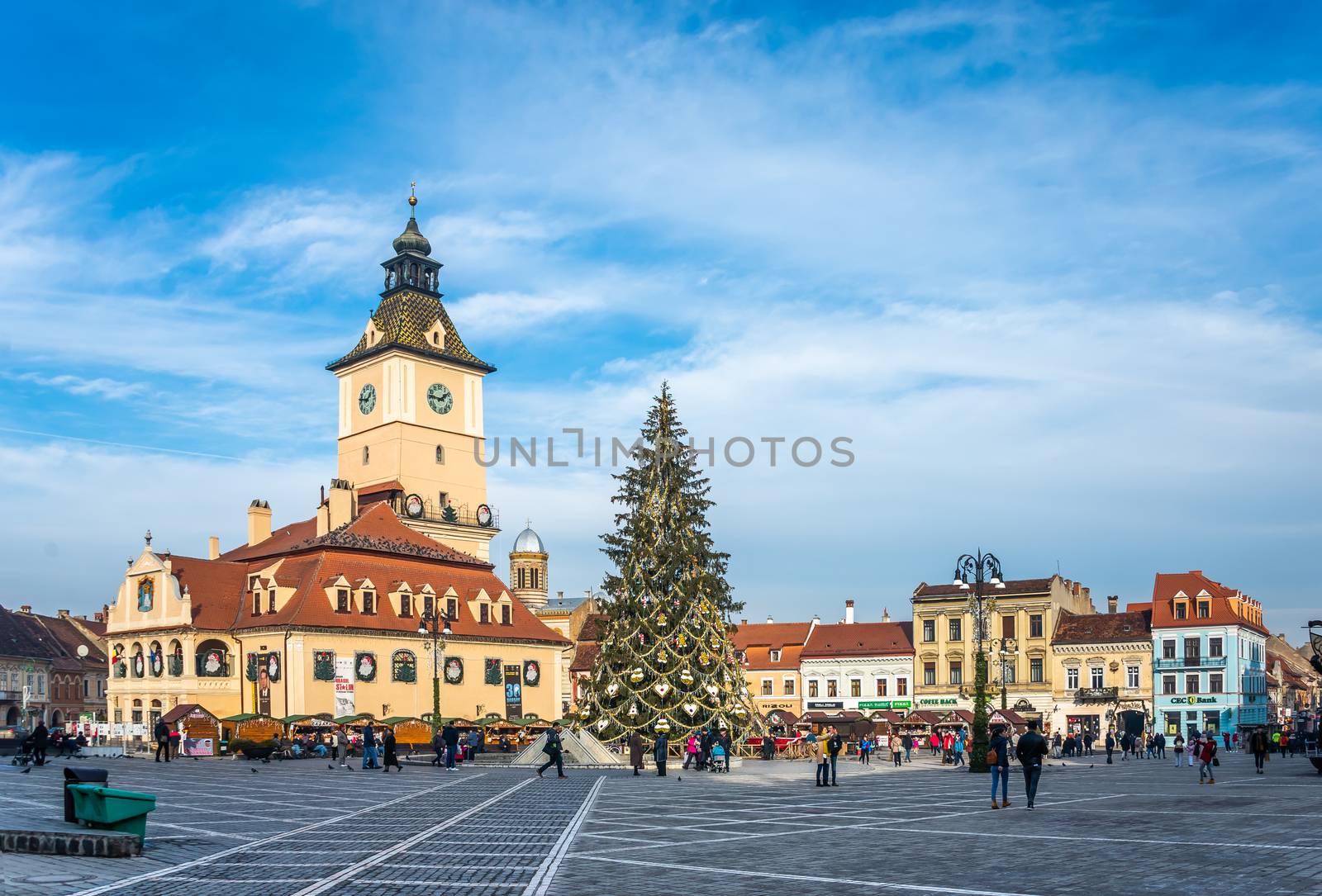 BRASOV, ROMANIA - 01.08.2018. Brasov Town Hall Square in Romania in a sunny winter day at Christmas and New Year holidays