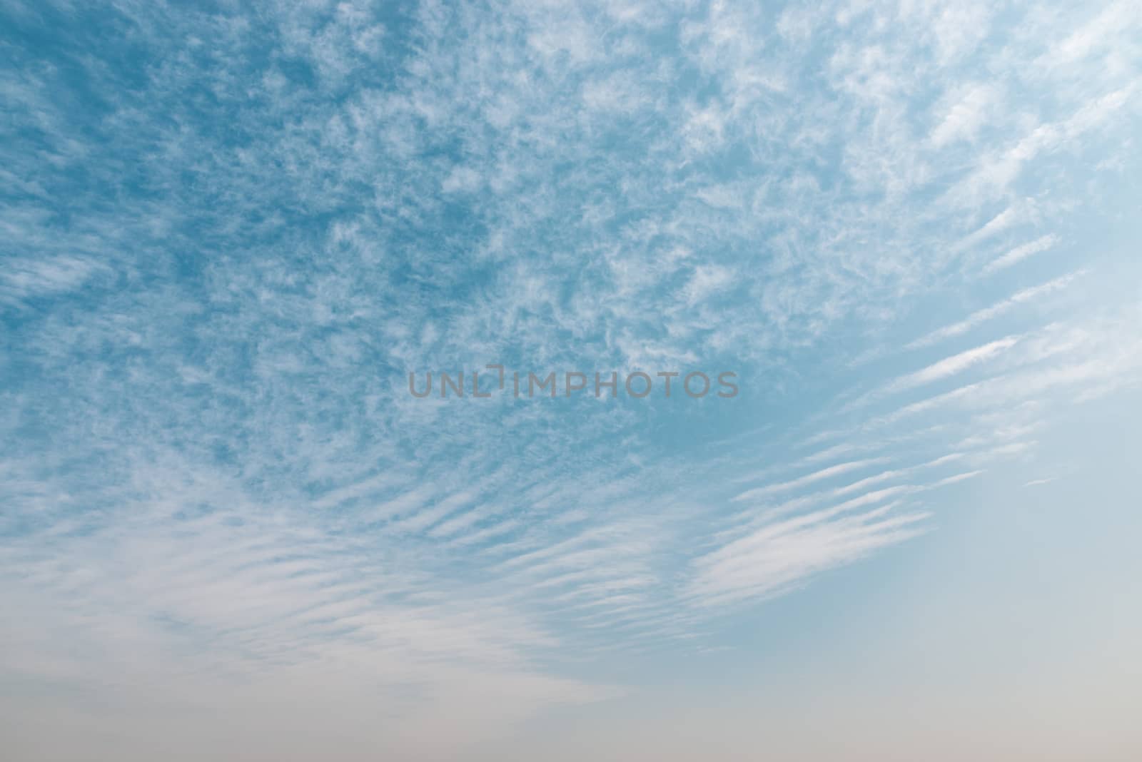 Blue sky with small clouds background