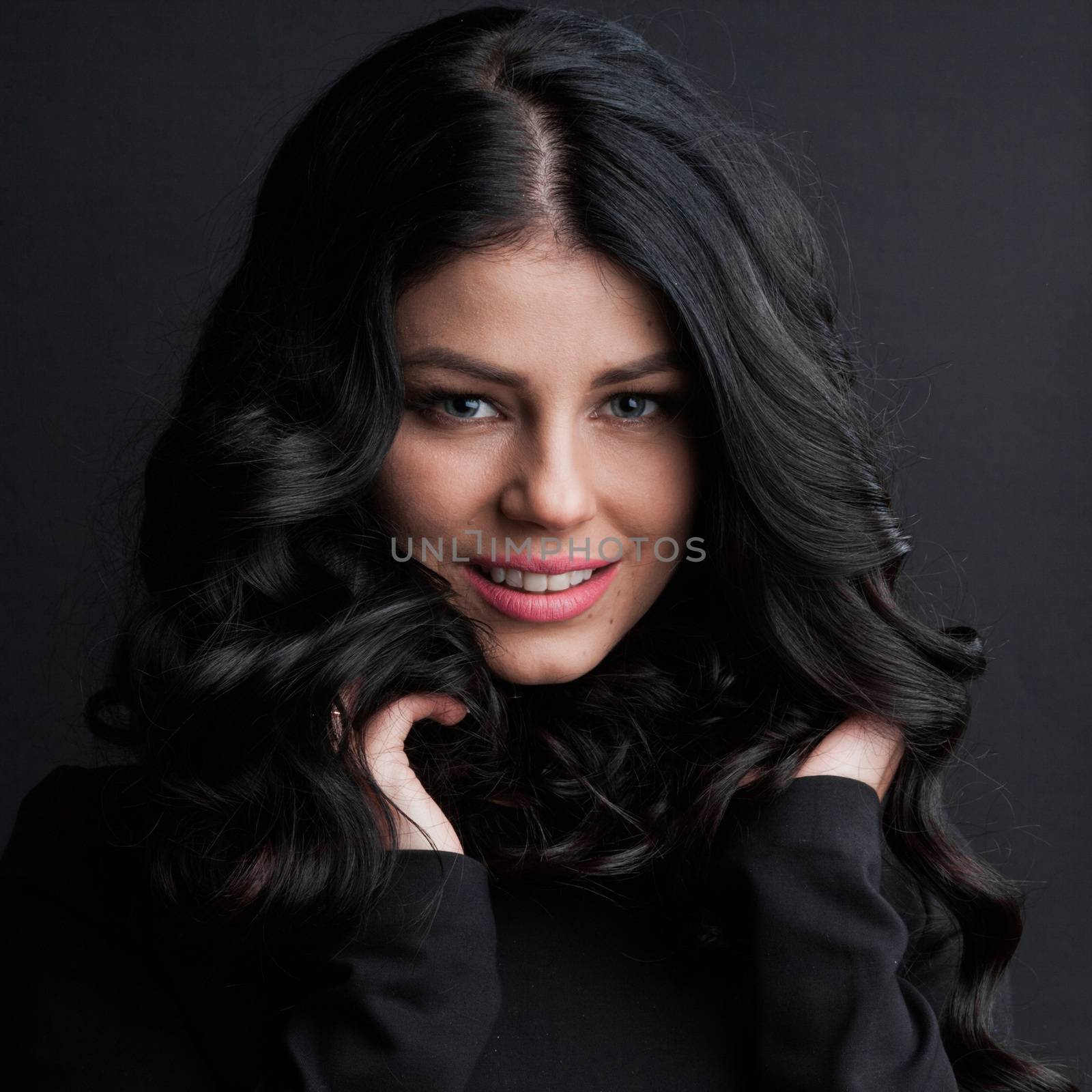 Portrait of gorgeous brunette with curly long hair