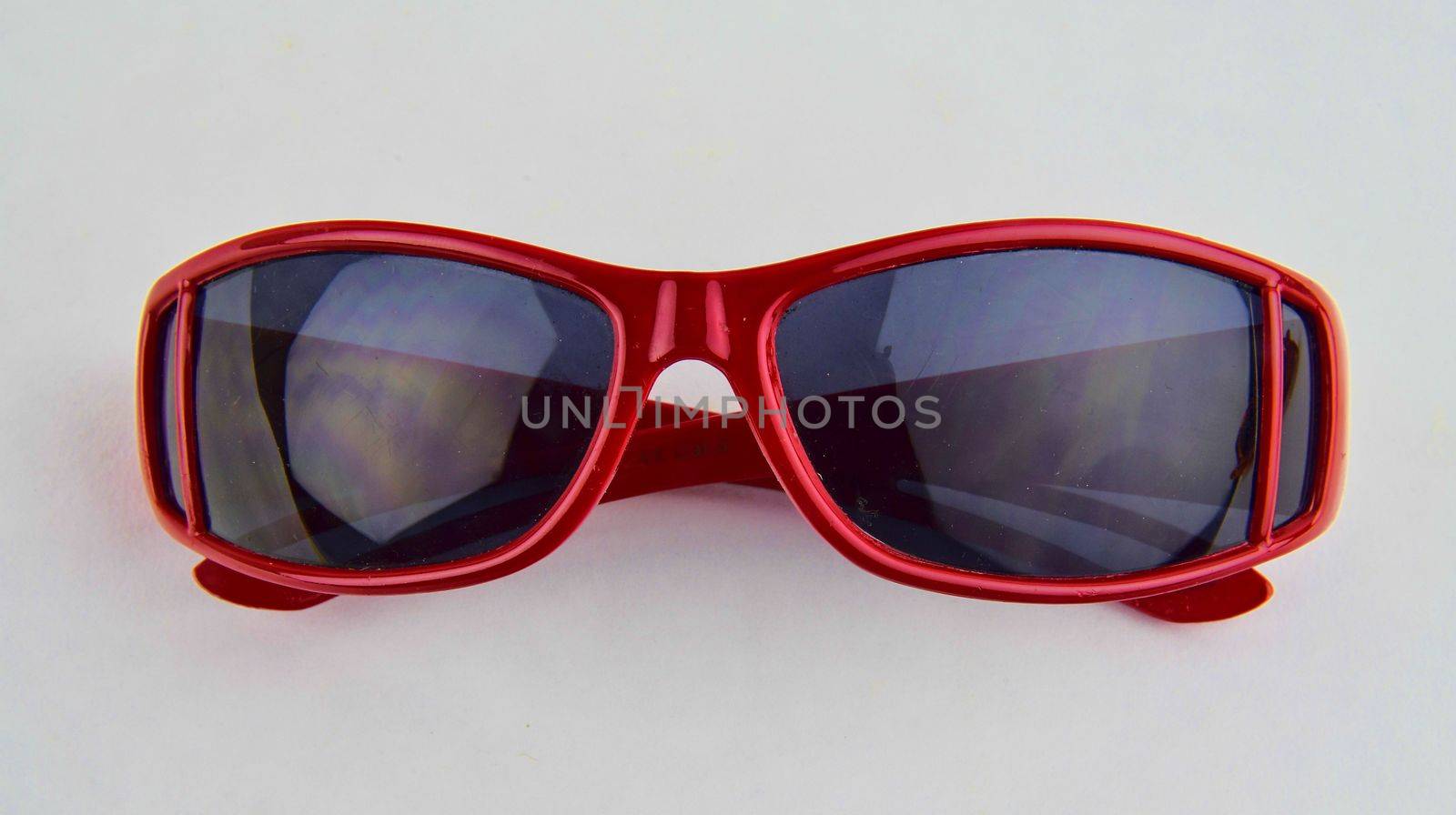 Stylish red sunglasses for children. Eye glasses on white background.