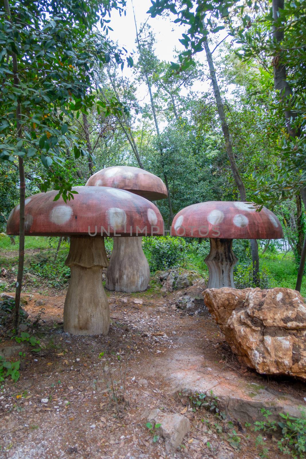 Gigantic red wooden mushrooms on a playground in woods