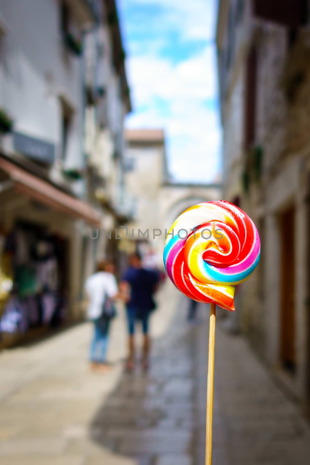 Colorful lolipop, city street as background by asafaric