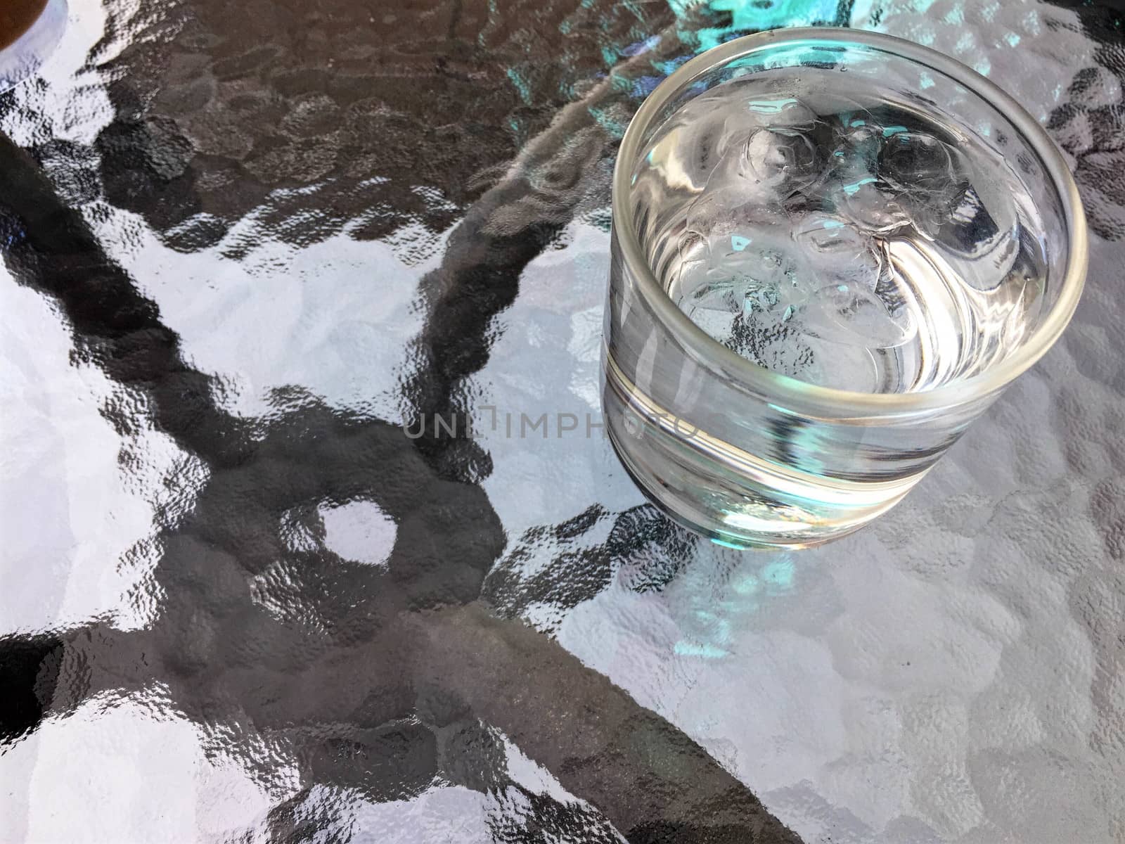 Drinking water and ice in glass on the table