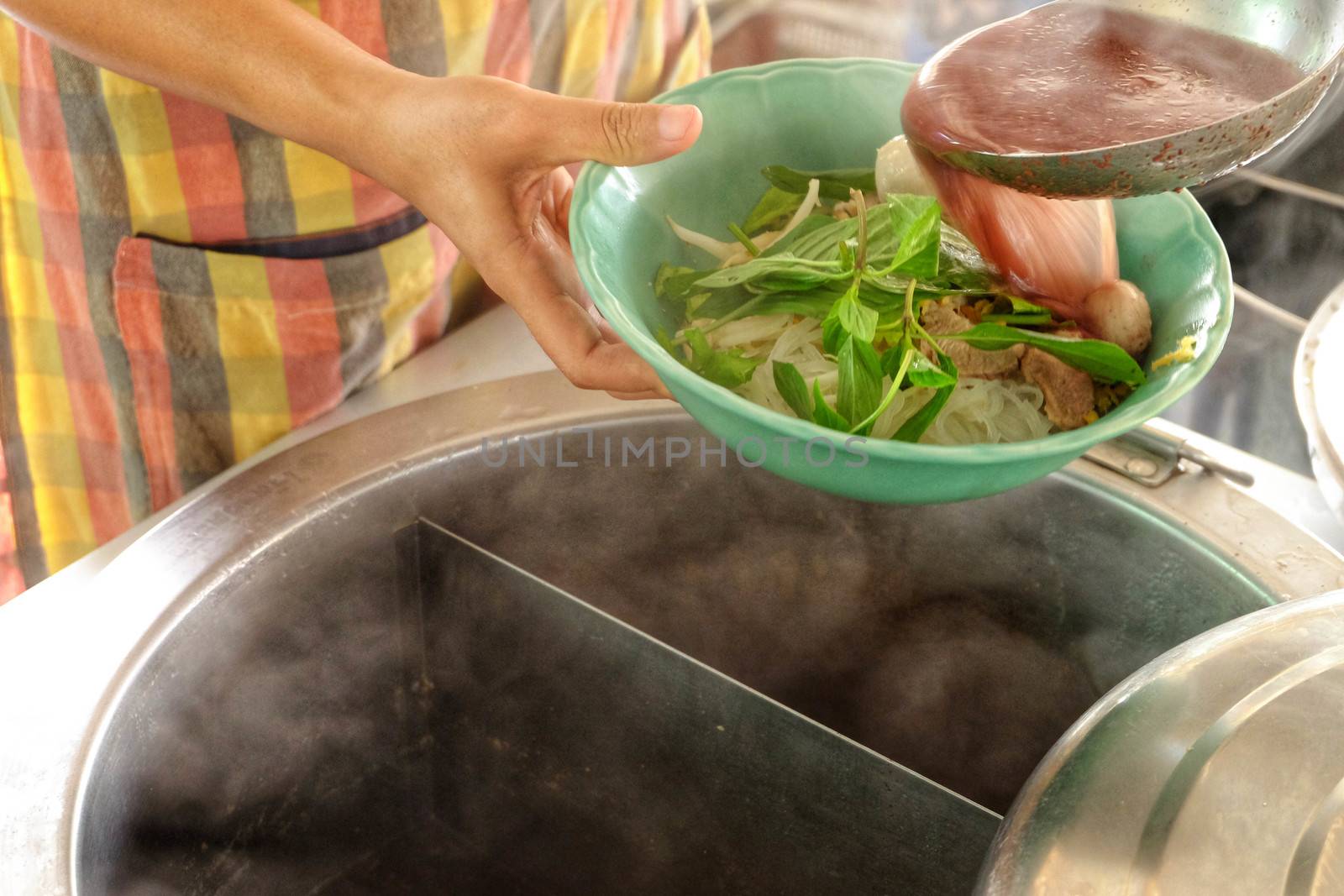 The ladle is drained in a bowl of noodles,Cooking noodle in thai by e22xua