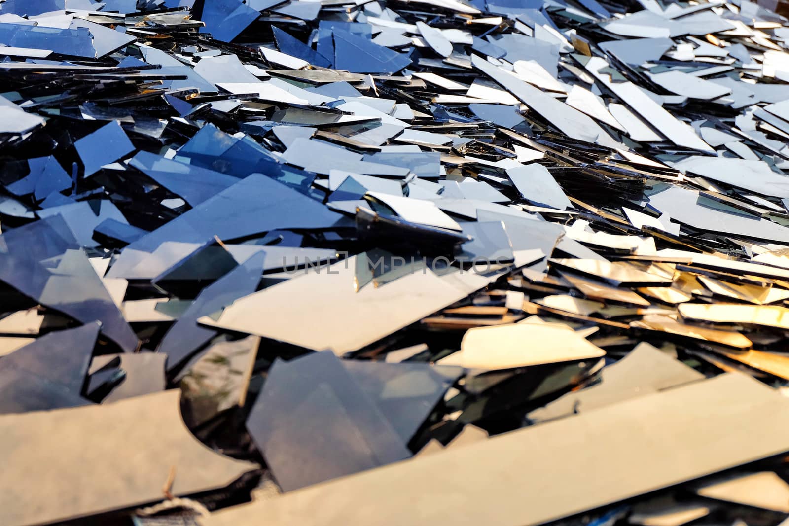 Broken black glass,Heap of mirror fragments morning light,broken black mirror to recycle.