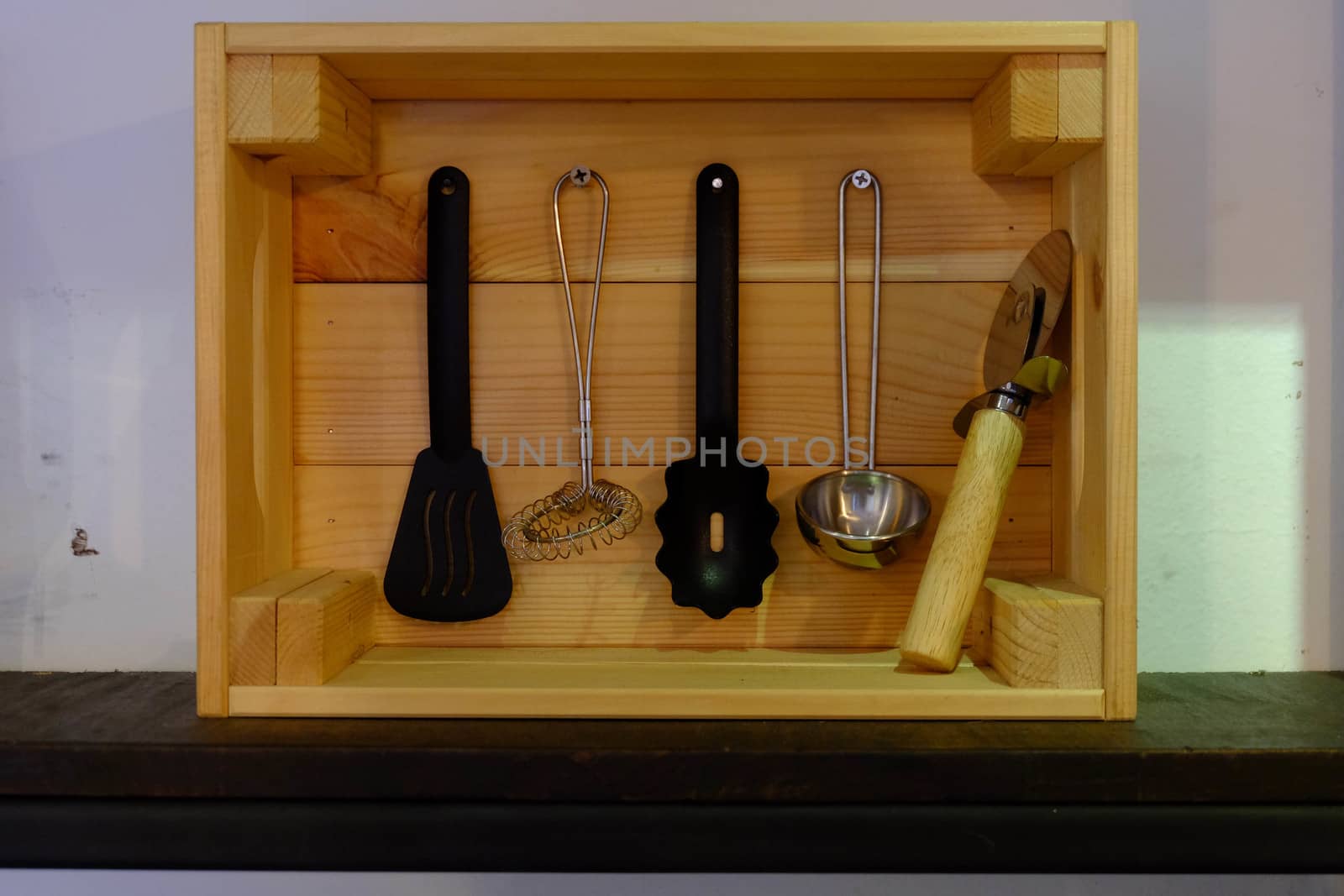 Kitchenware in a wooden box with a rectangular shape.