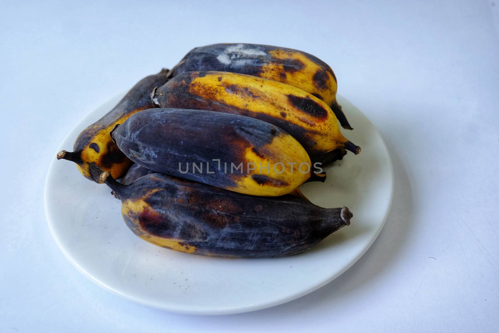 Rotten banana mold Isolated in a white dish on white background.