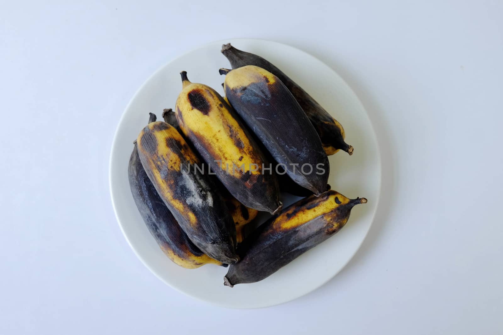 Rotten banana Isolated in a white dish on white background. by e22xua
