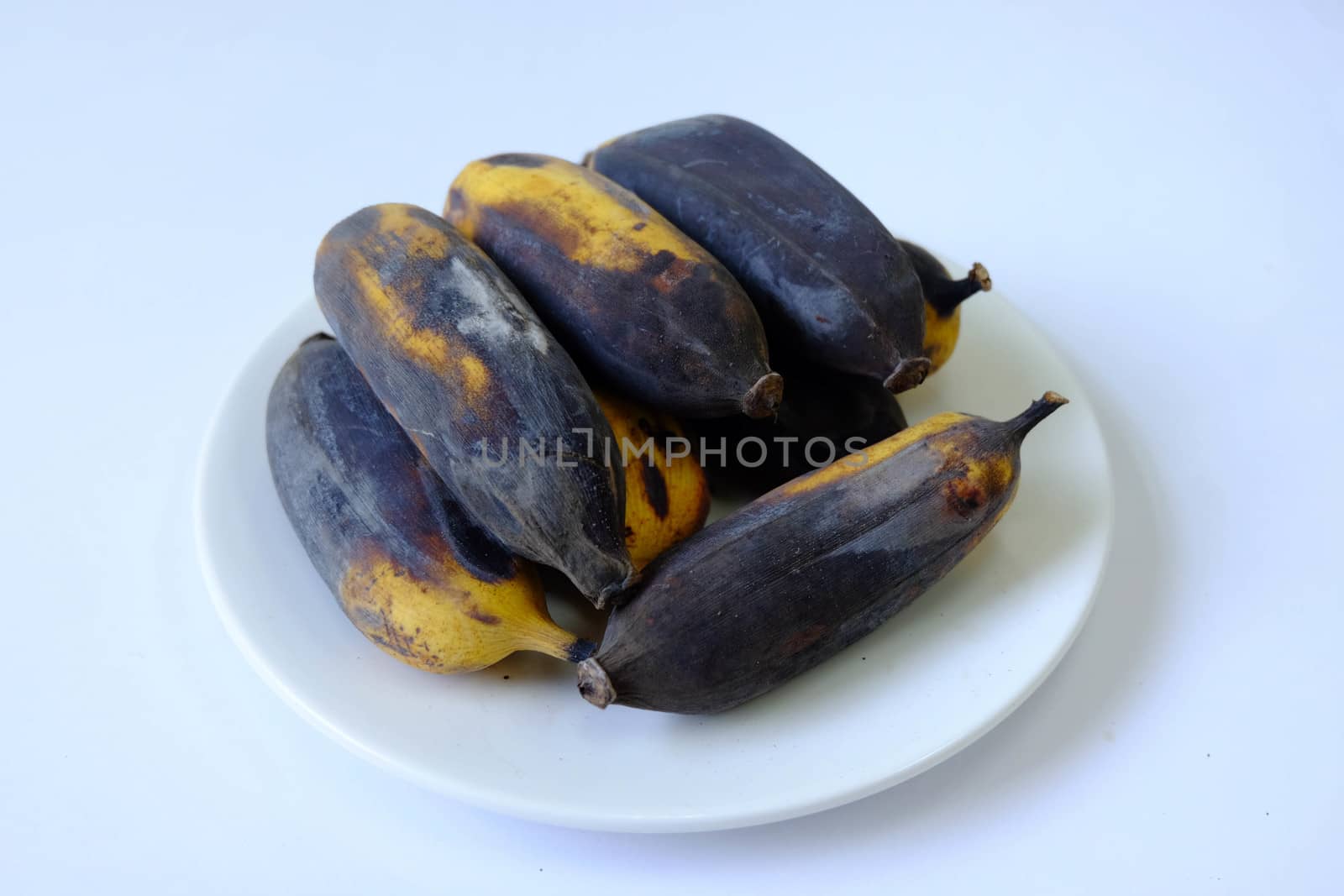 Rotten banana mold Isolated in a white dish on white background.