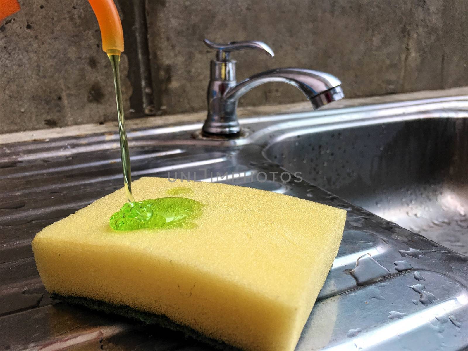Yellow sponge and Green dishwashing liquid