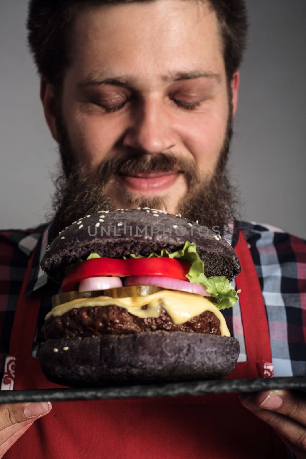 Man enjoy smelling fresh self made burger close up