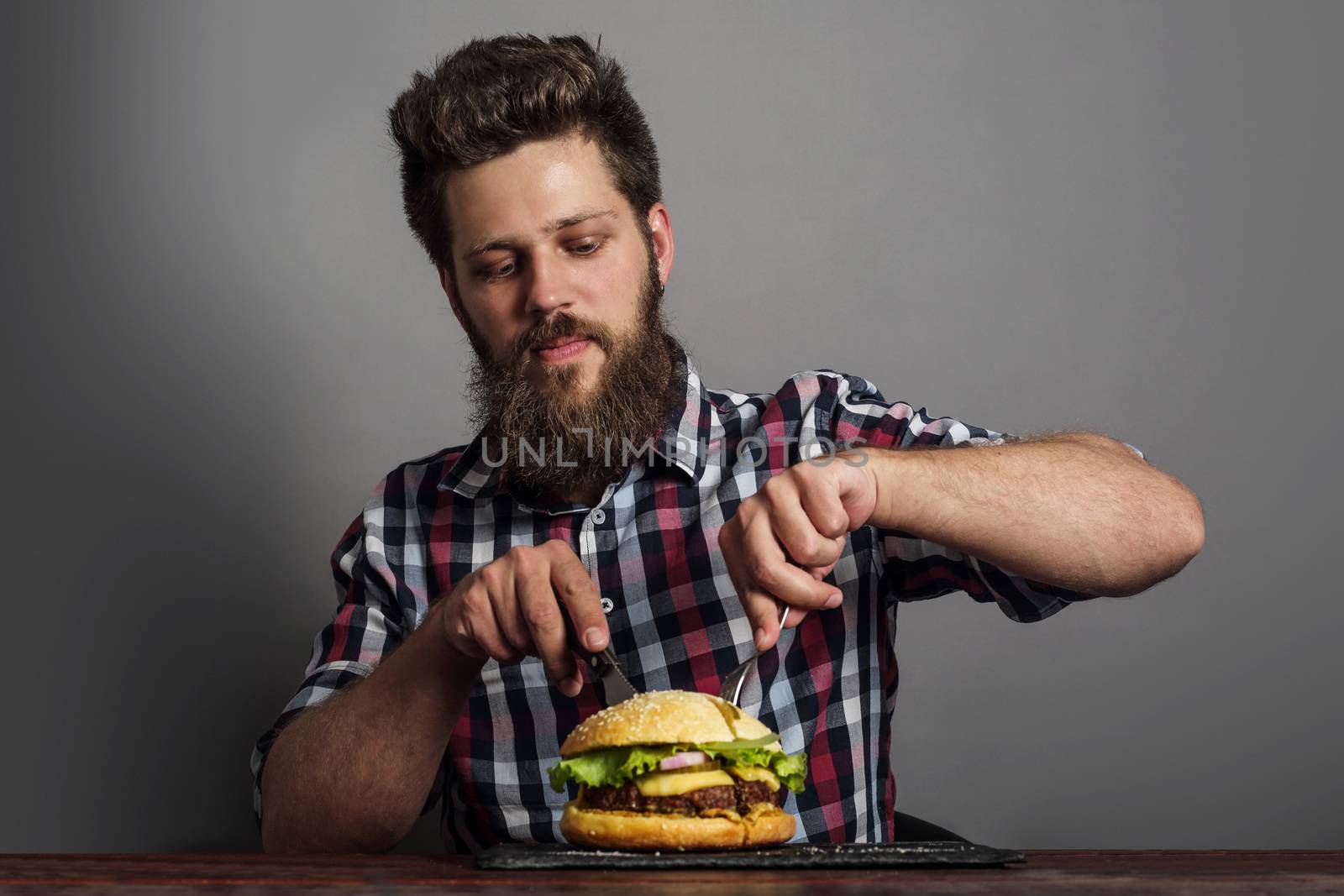 Man eating fresh self made burger close up