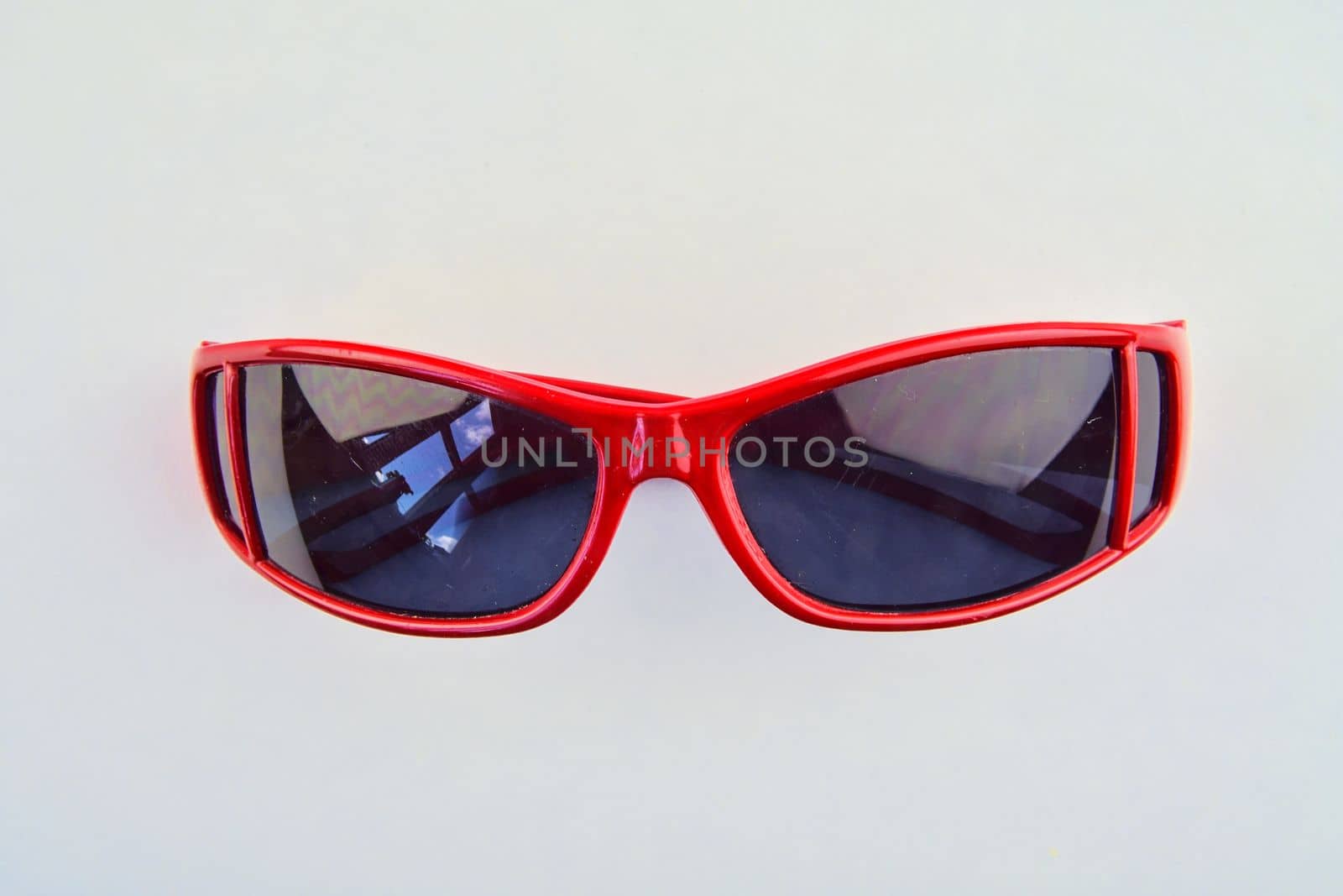 Stylish red sunglasses for children. Eye glasses on white background.