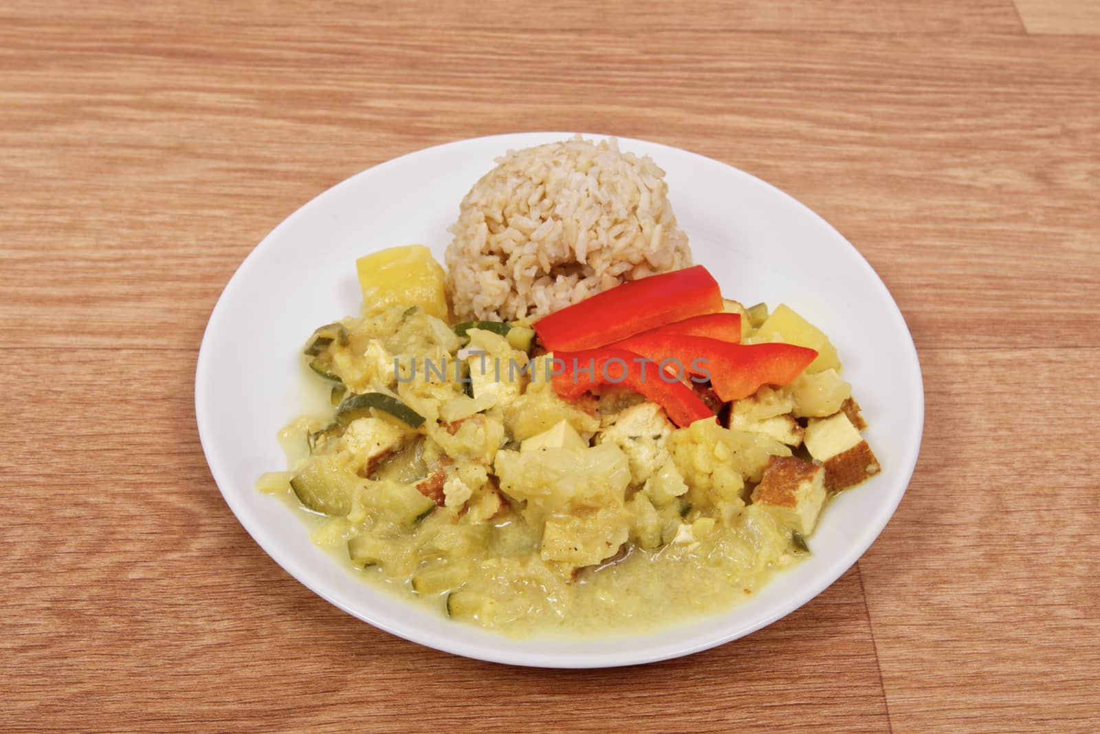 Cauliflower mixture with curry and rice on a table by neryx