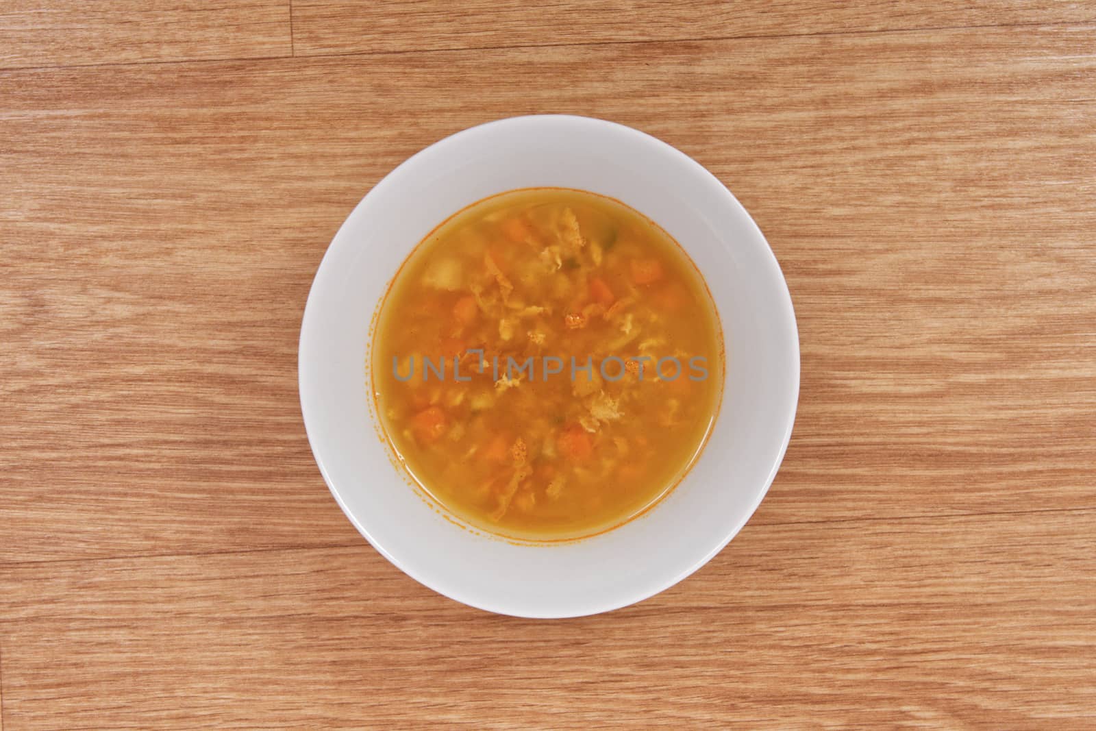 Groat soup with vegetables on a table by neryx