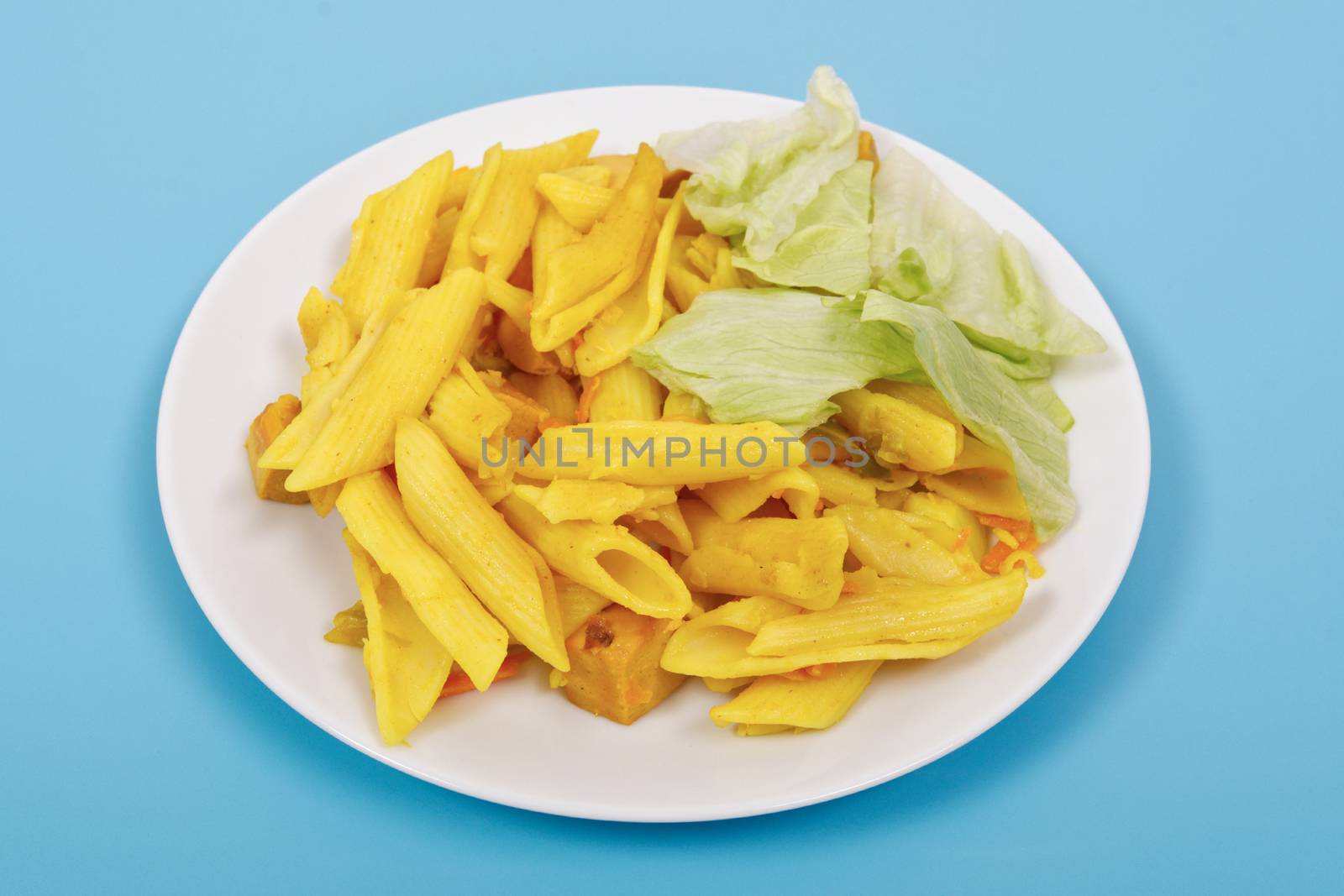 Baked pasta with curry on a blue background