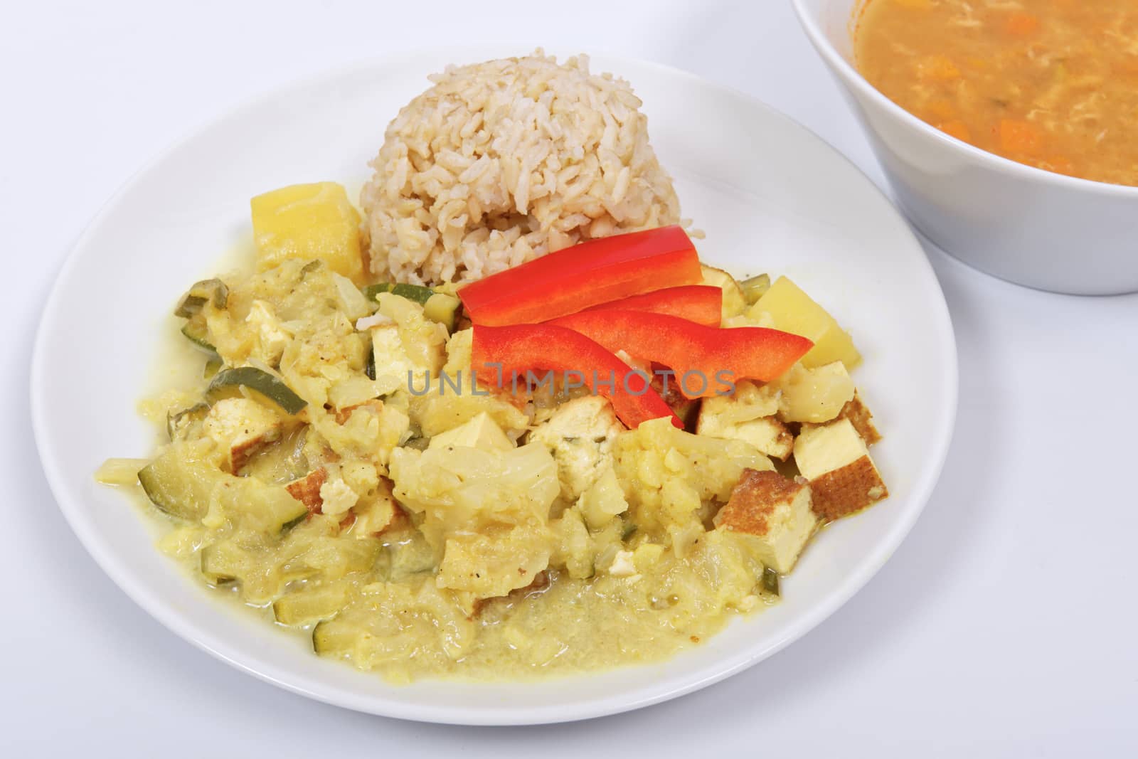 Cauliflower mixture with curry and rice on a white by neryx