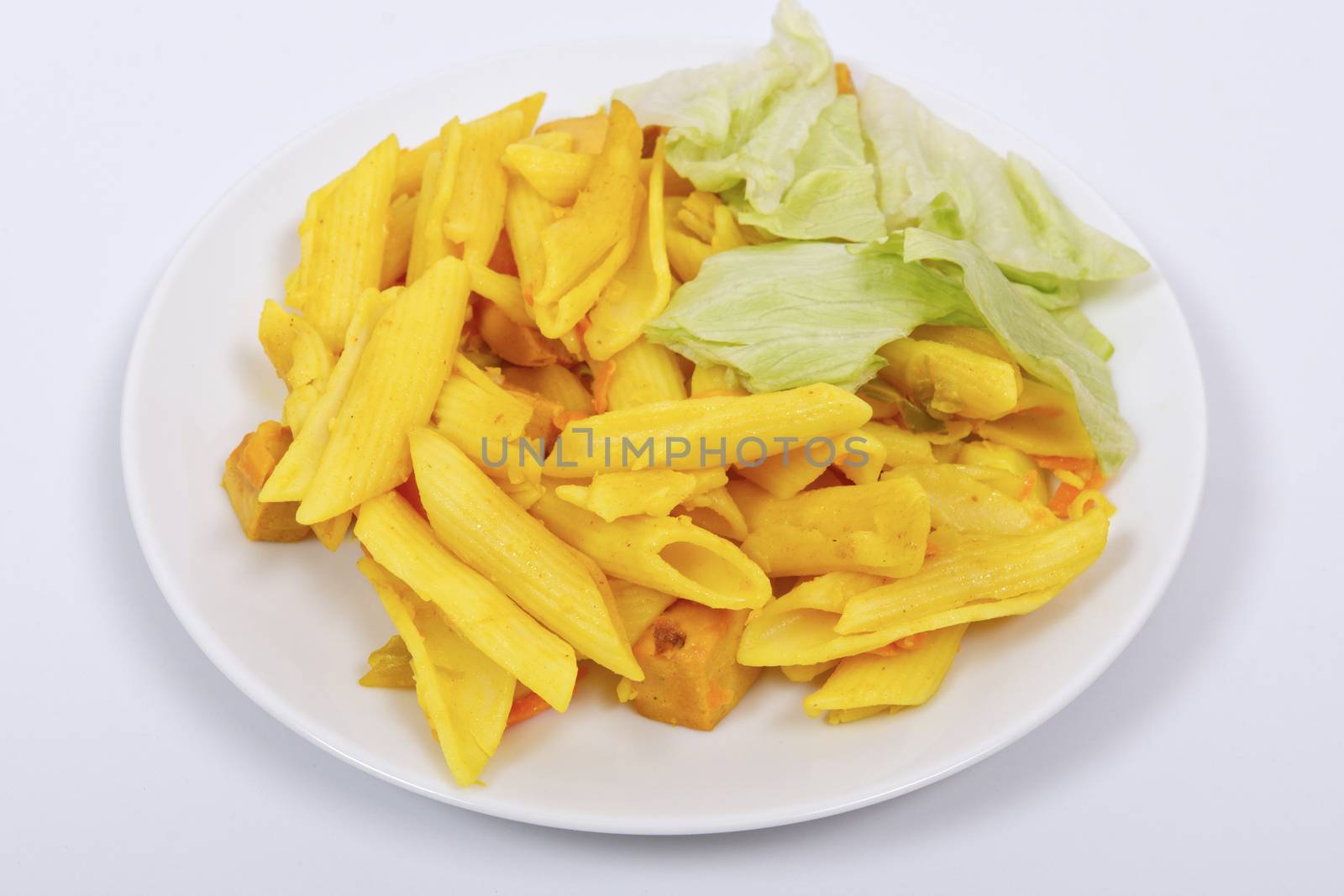 Baked pasta with curry on a white background