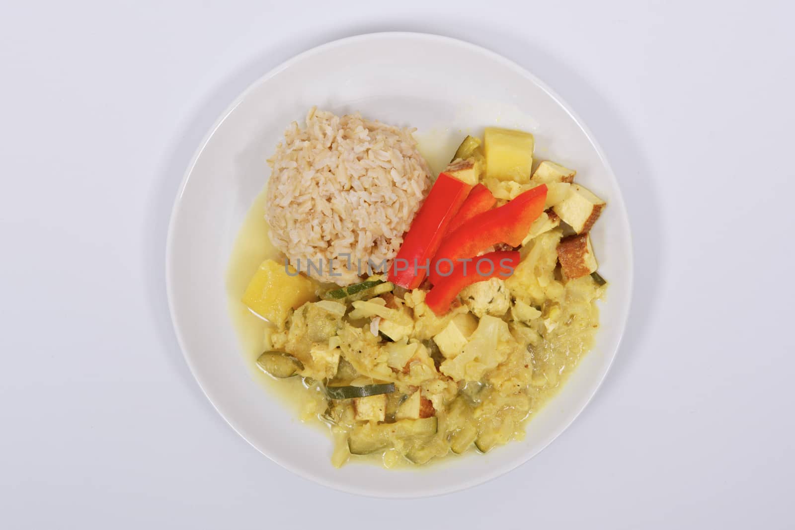 Cauliflower mixture with curry and rice on a white by neryx