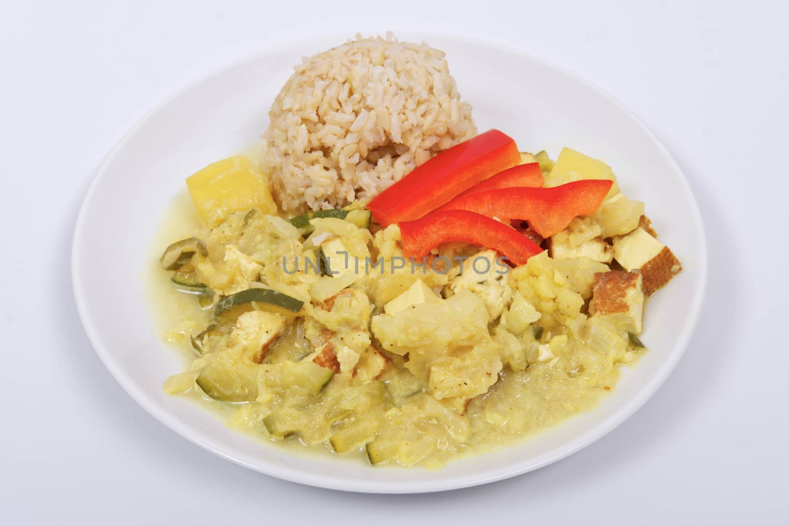 Cauliflower mixture with curry and rice on a white background