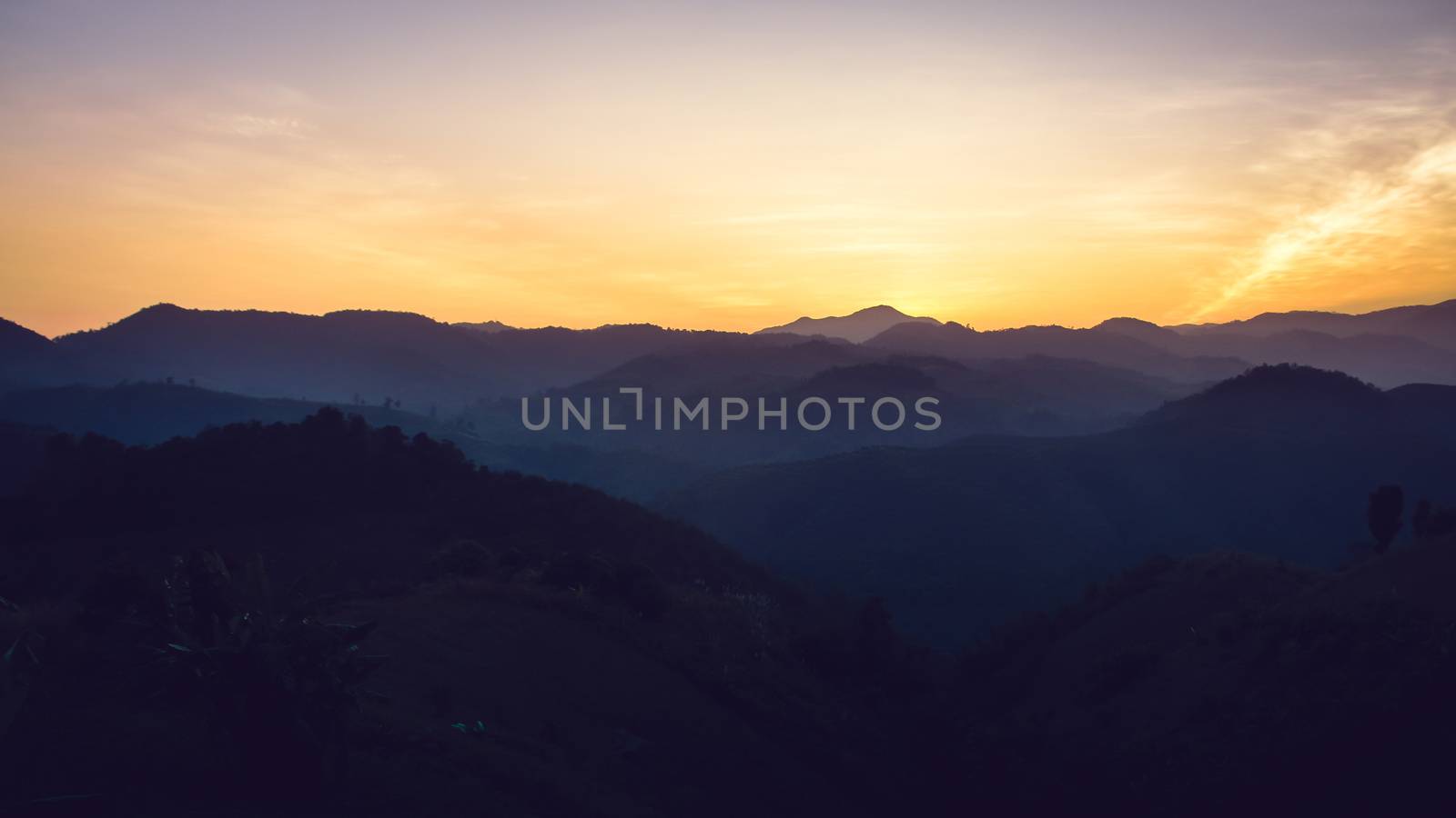 Landscape of forest mountains on sunset by apichart