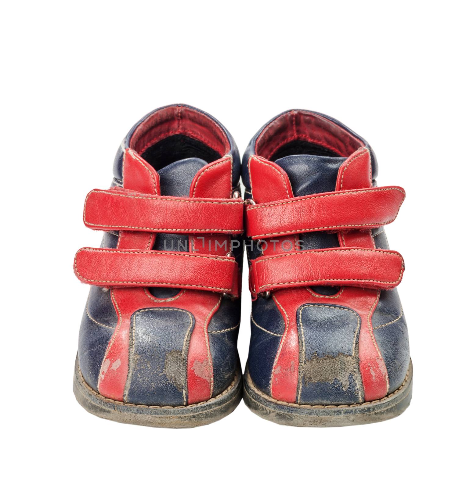 Used red-blue child shoes isolated on white