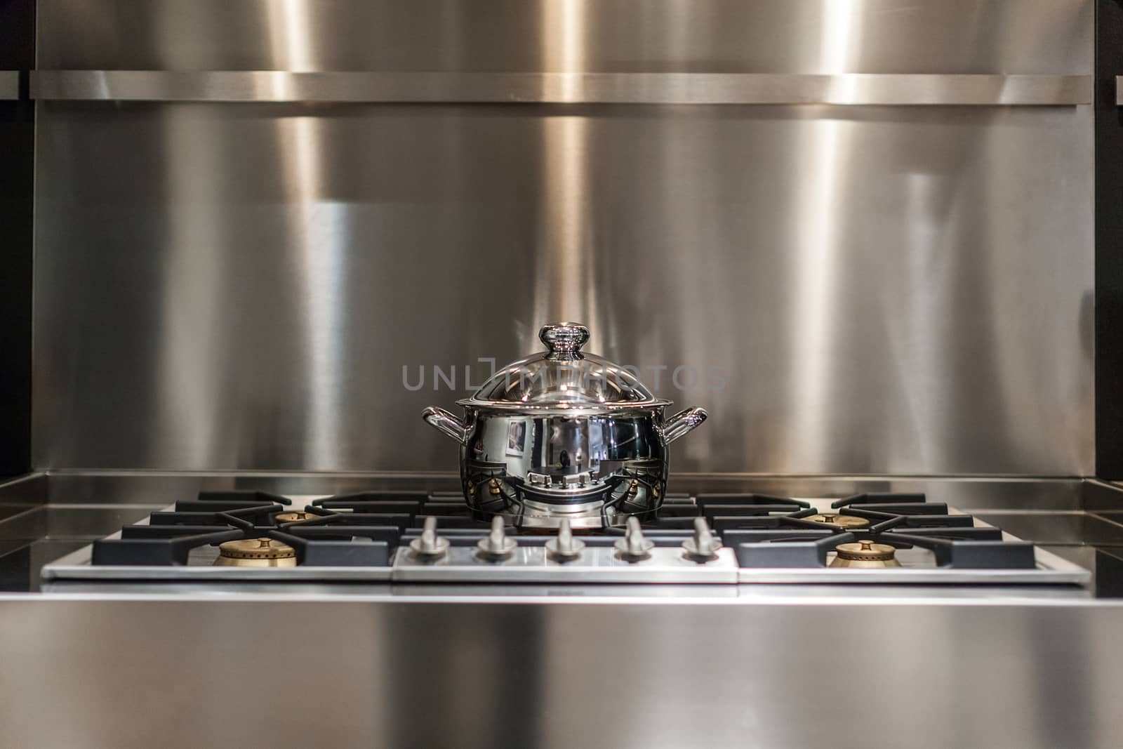 new stainless steel saucepan on modern kitchen range