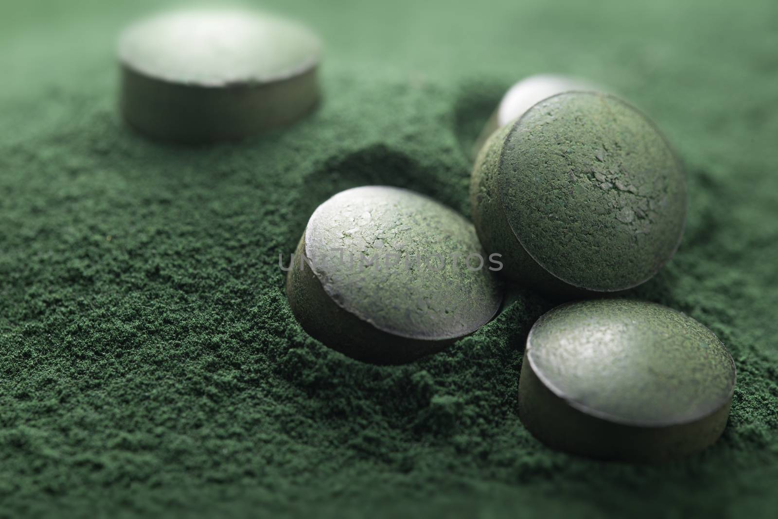 Close up of Atisanal Spirulina Tablets on Powder Background With Low Depth of Field. Horizontal Image