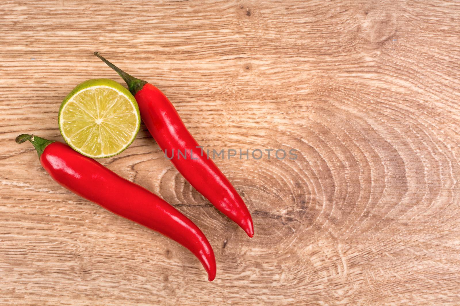 Fresh chilli and lime on a wooden table
