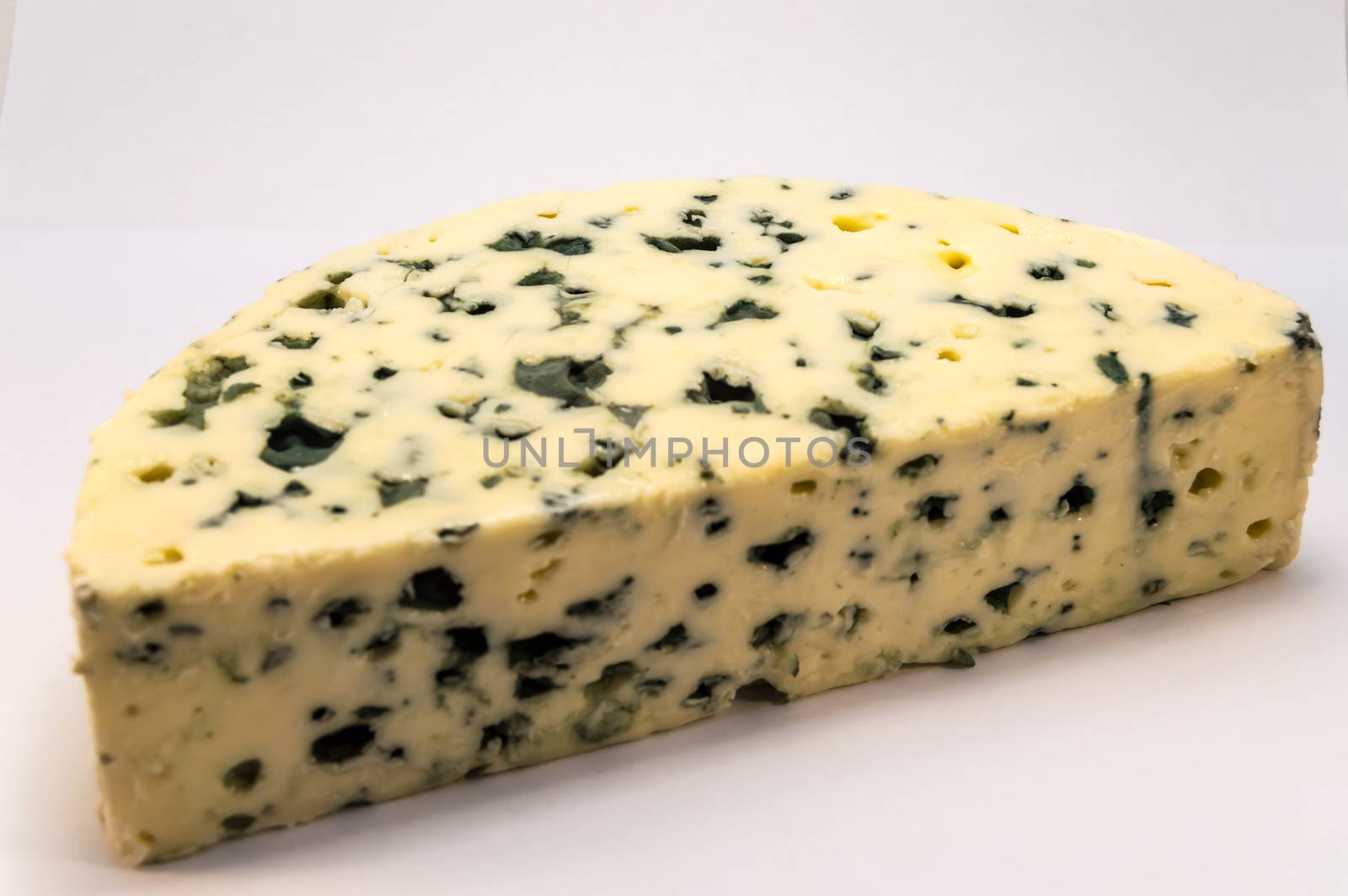 Half moon of Roquefort cheese from France on a white background