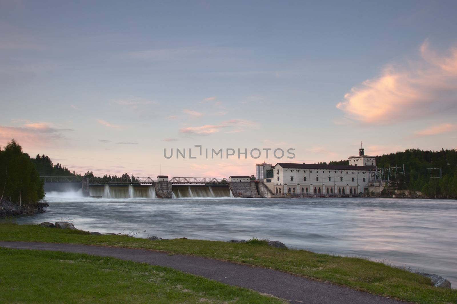 Rånåsfoss dam and power station in Akershus, Norway. Water is flowing over the dam. Long exposure.