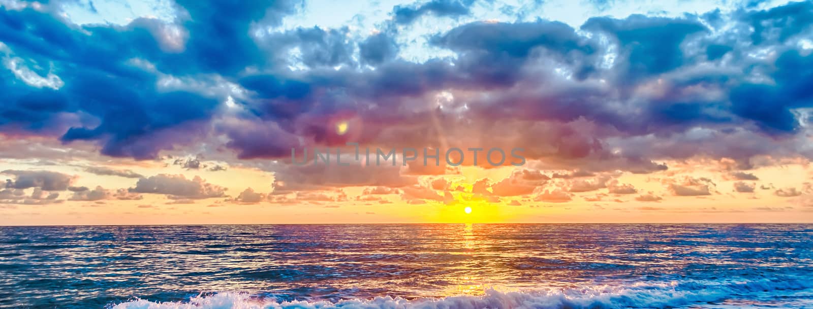 Sunset on the mediterranean sea with a scenic cloudy sky, Italy