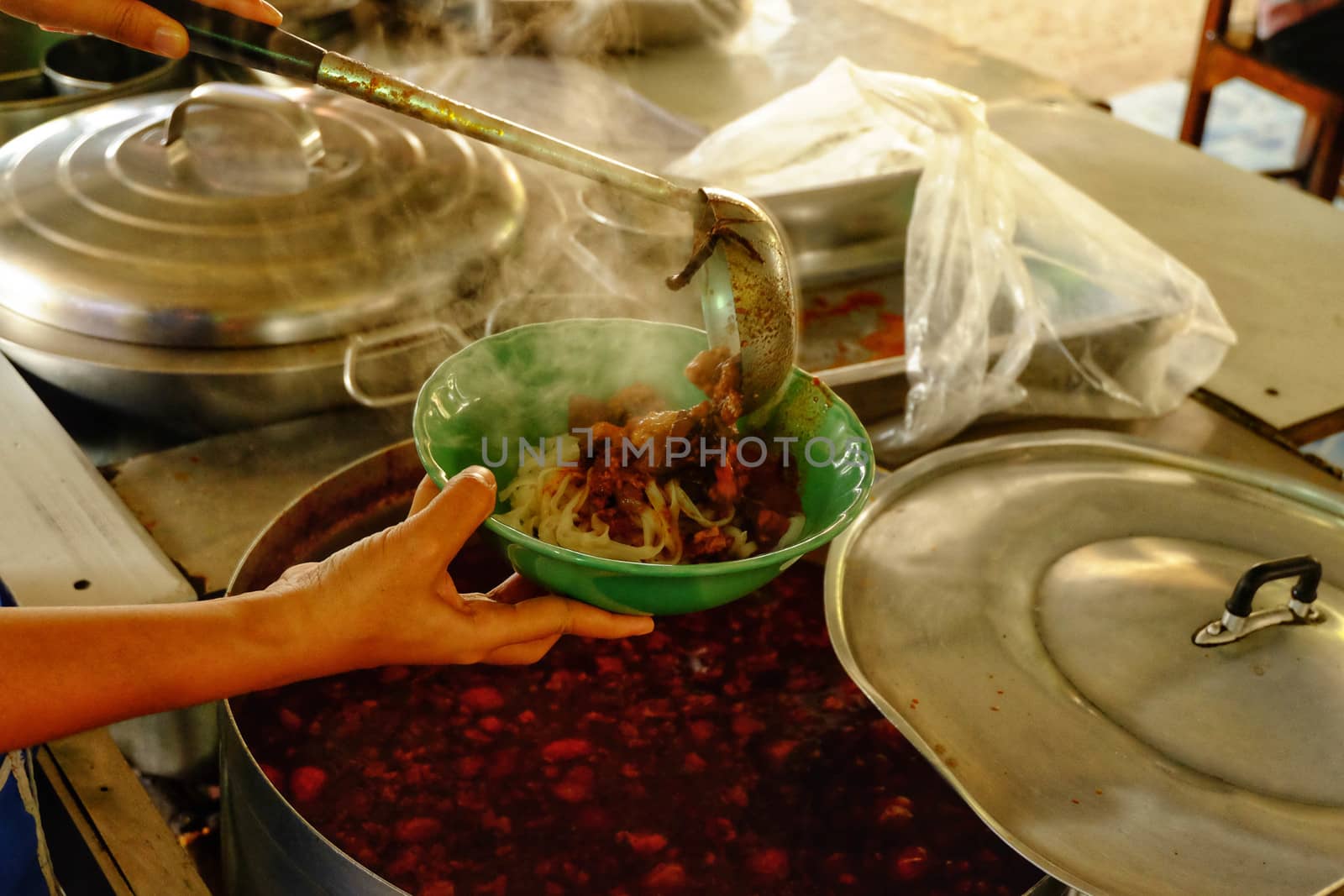 A spicy soup ladle in a cup, a spicy soup in northern Thailand.Northern Thai food made of rice vermicelli or rice noodle in spicy sauce with pork or meat.