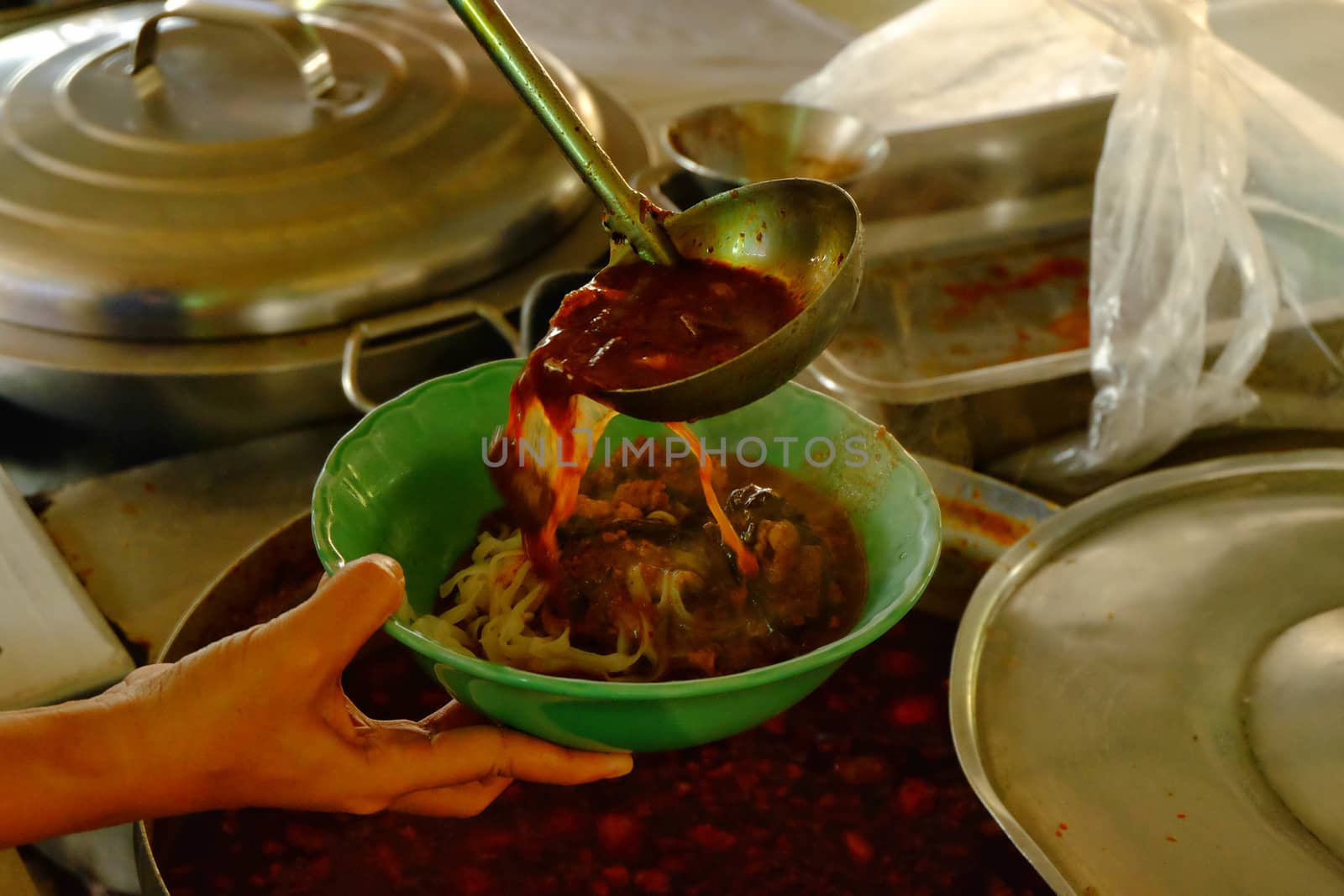 A spicy soup ladle in a cup, a spicy soup in northern Thailand.Northern Thai food made of rice vermicelli or rice noodle in spicy sauce with pork or meat.