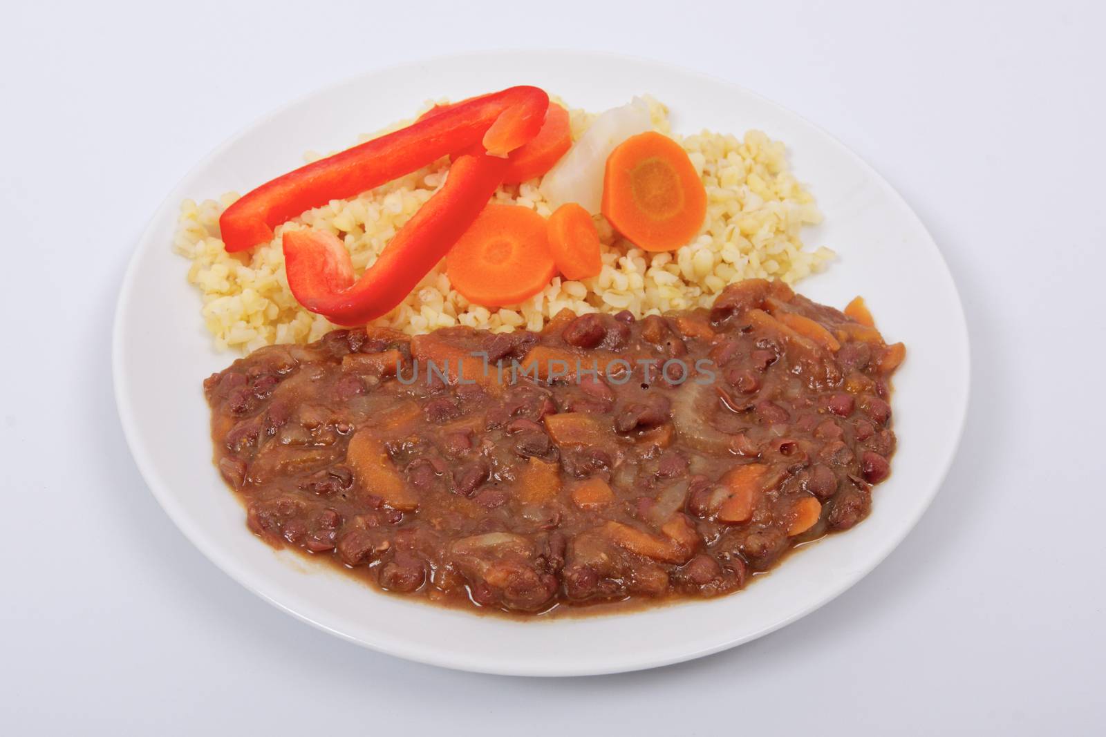 Azuki with vegetables on steam and bulgur on a white background