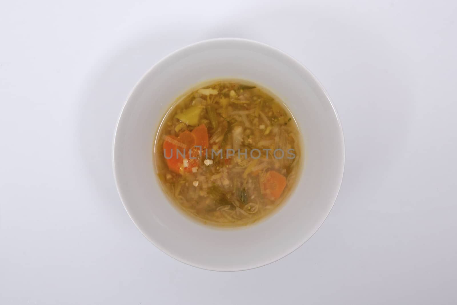 Miso vegetable soup with vegetables on a white background