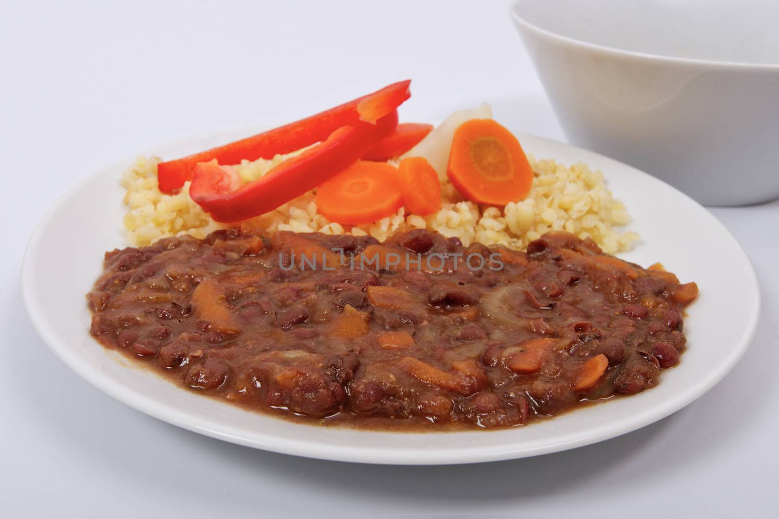 Azuki with vegetables on steam and bulgur on a white background