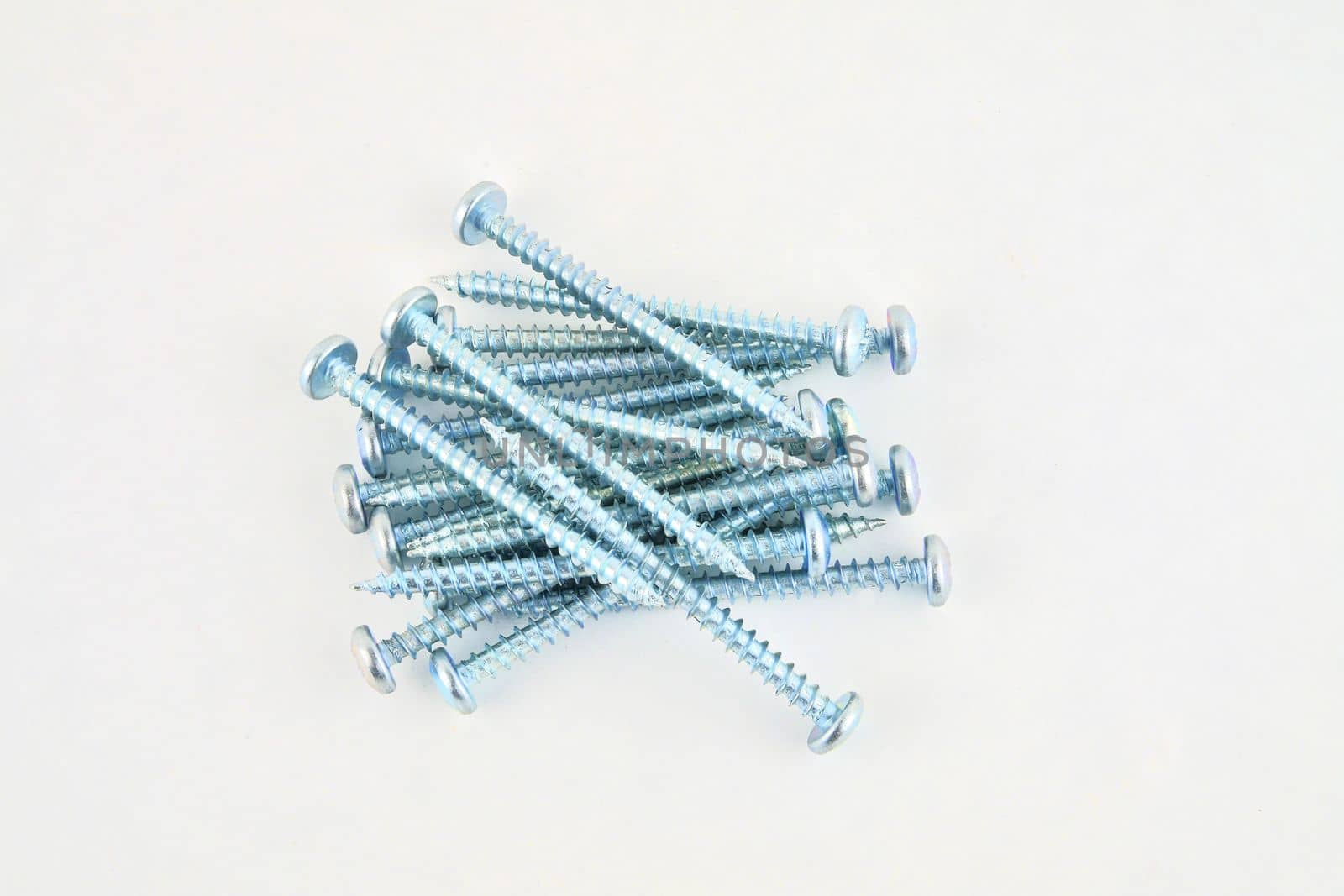 Set of screws for construction on a white background, metal screw, iron screw, chrome screw, screws as a background, wood screw. Close-up by roman_nerud